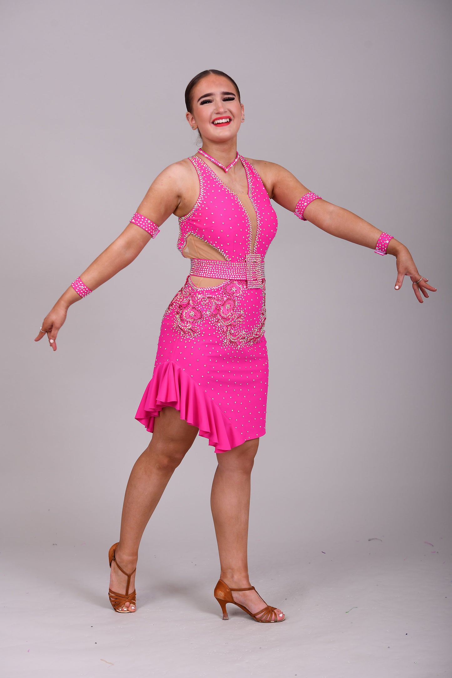 156 Flo Pink cut out Latin Dress. Full frill skirt with detachable belt. Flo pink appliqués decorated in Rose & AB stones
