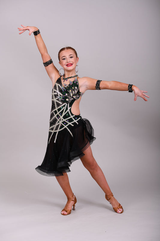 097 Black Heavily Stoned Gem Latin Dress. 3D design to the chest. Backless dress with crinoline edged skirt. Stoned in AB