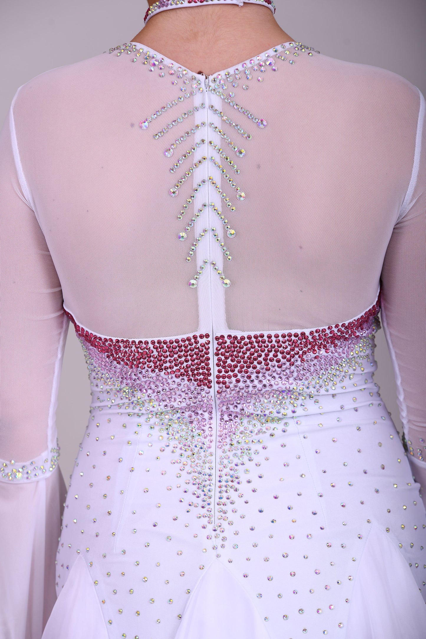 207 Pale Pink & White Ombré Ballroom Dress. Scoop neck & High mesh back. Feature stoning at the chest in rose, light rose & AB. Feather detailing to bell sleeves.