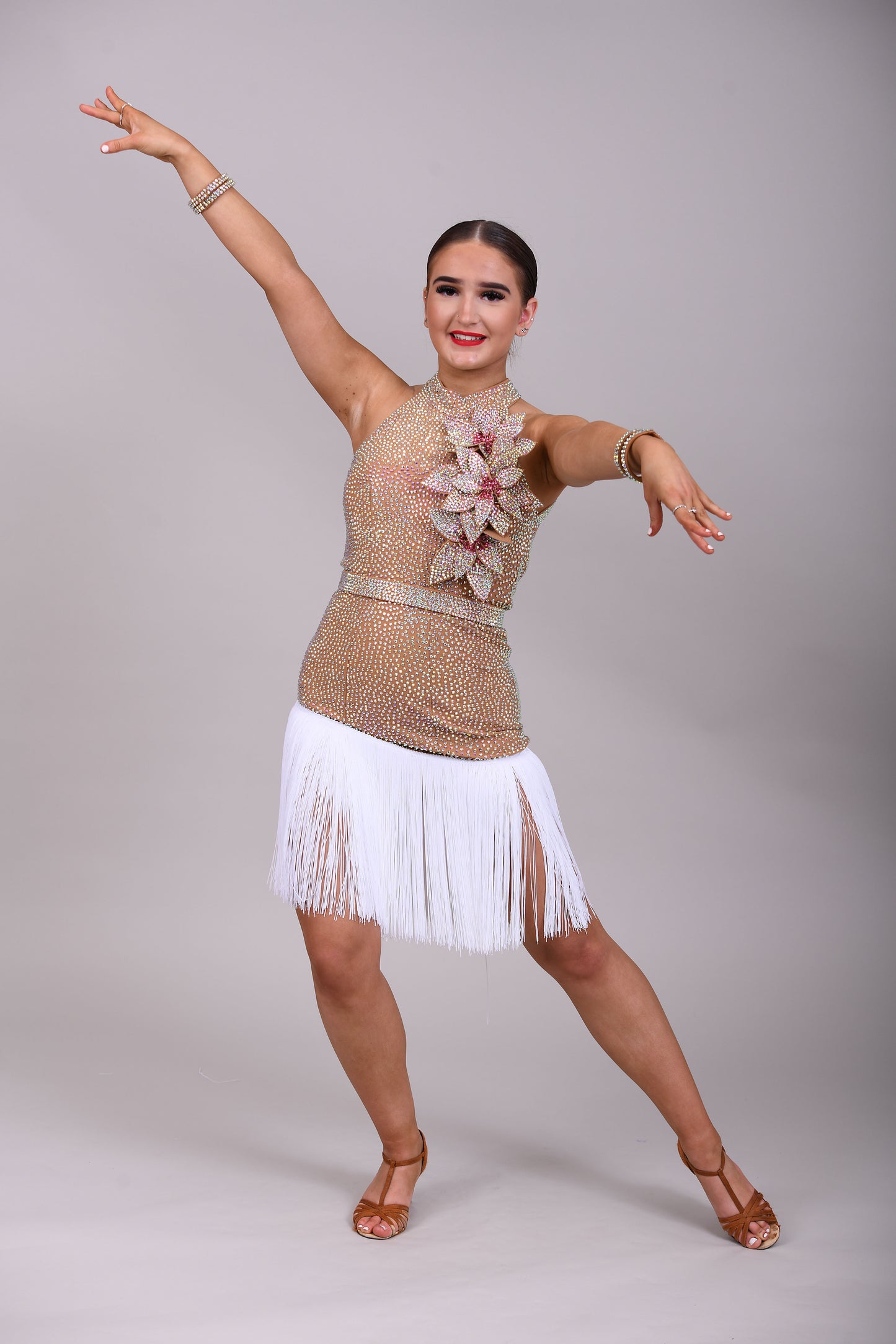 299 Tan & white Latin Dress. 3D flower detailing with white fringe skirt. AB & Rose stoning with separate belt.