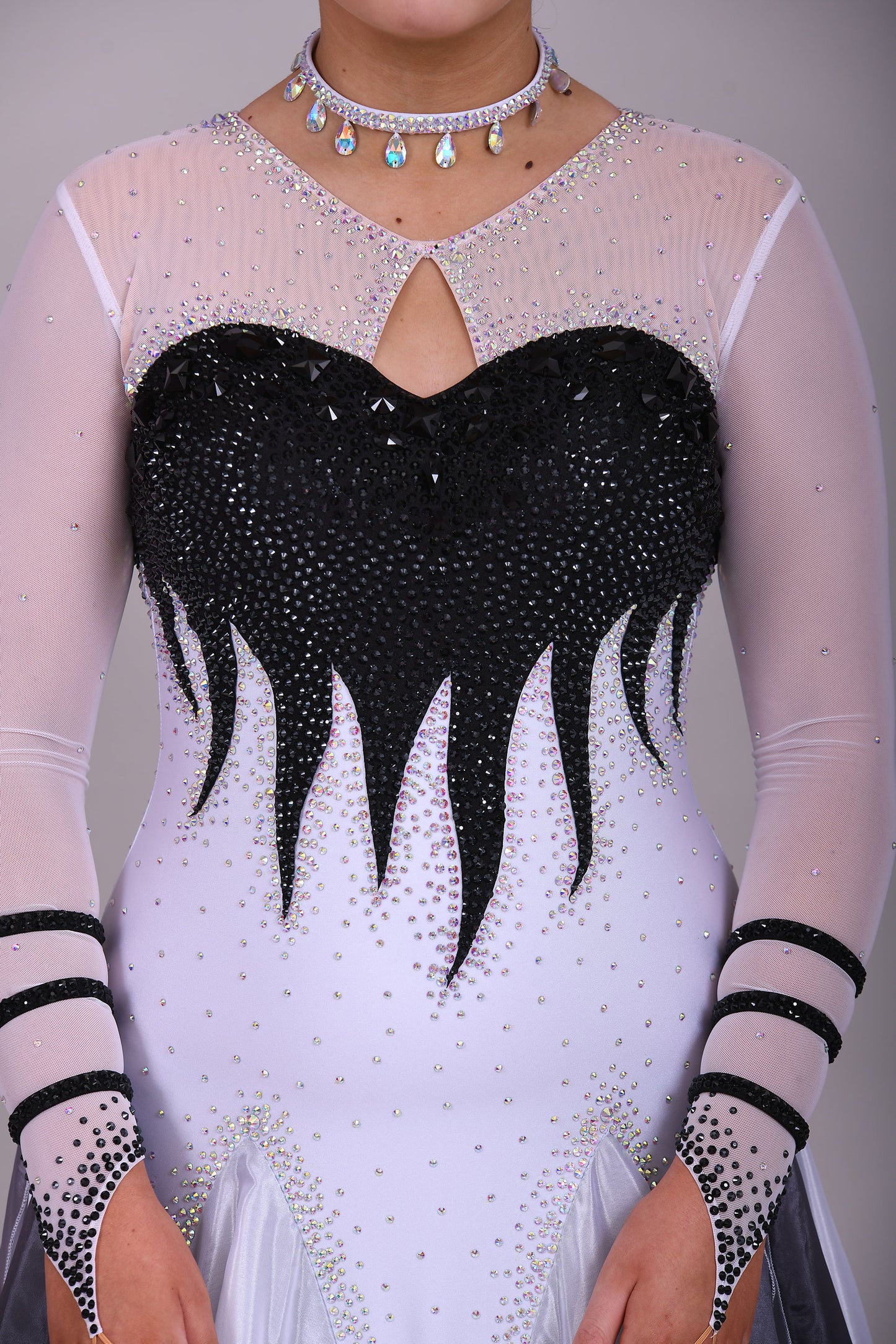 01140 Black & White Ombre Competition Ballroom Dance Dress Upper chest heavily stoned Jet. Pearl Chiffon Ombre skirts. The upper chest is white mesh with skin fabric underneath, giving the illusion of skin. Detachable Floats.