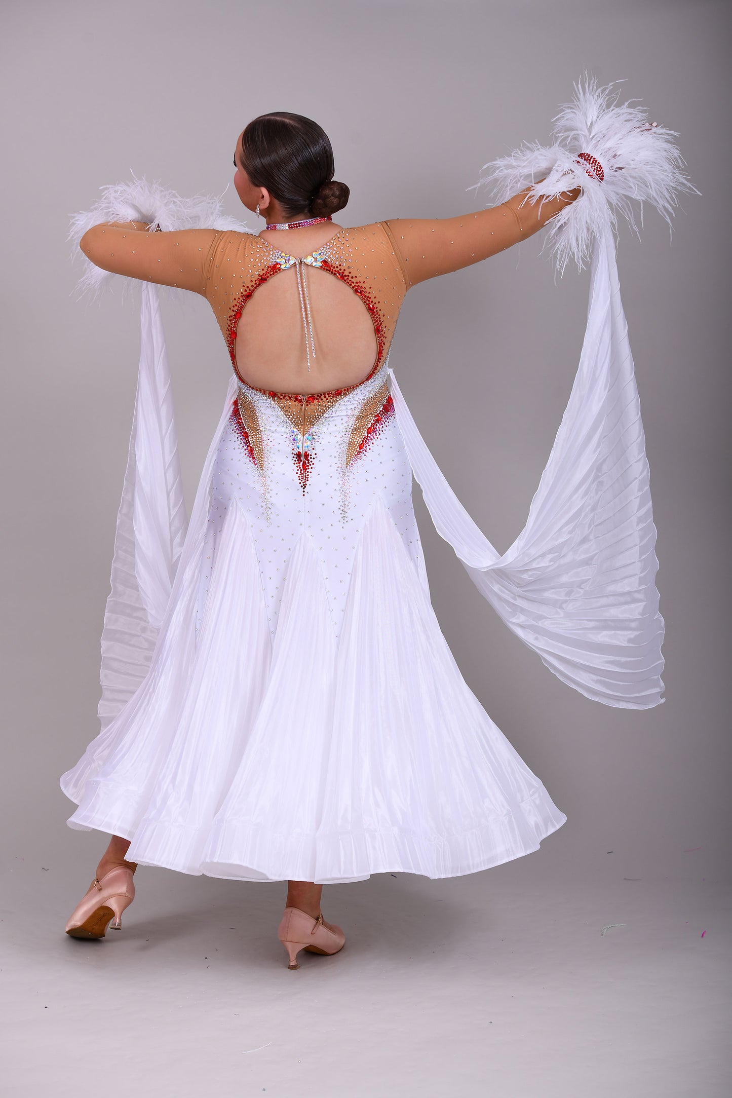 011 White & Mid Tan Competition Ballroom Dance Dress. Pleated pearl Chiffon skirt with beautiful keyhole Back. Stoned accents in Siam, Siam AB, AB & Golden Shadow. Comes with detachable pleated floats and feather cuffs.