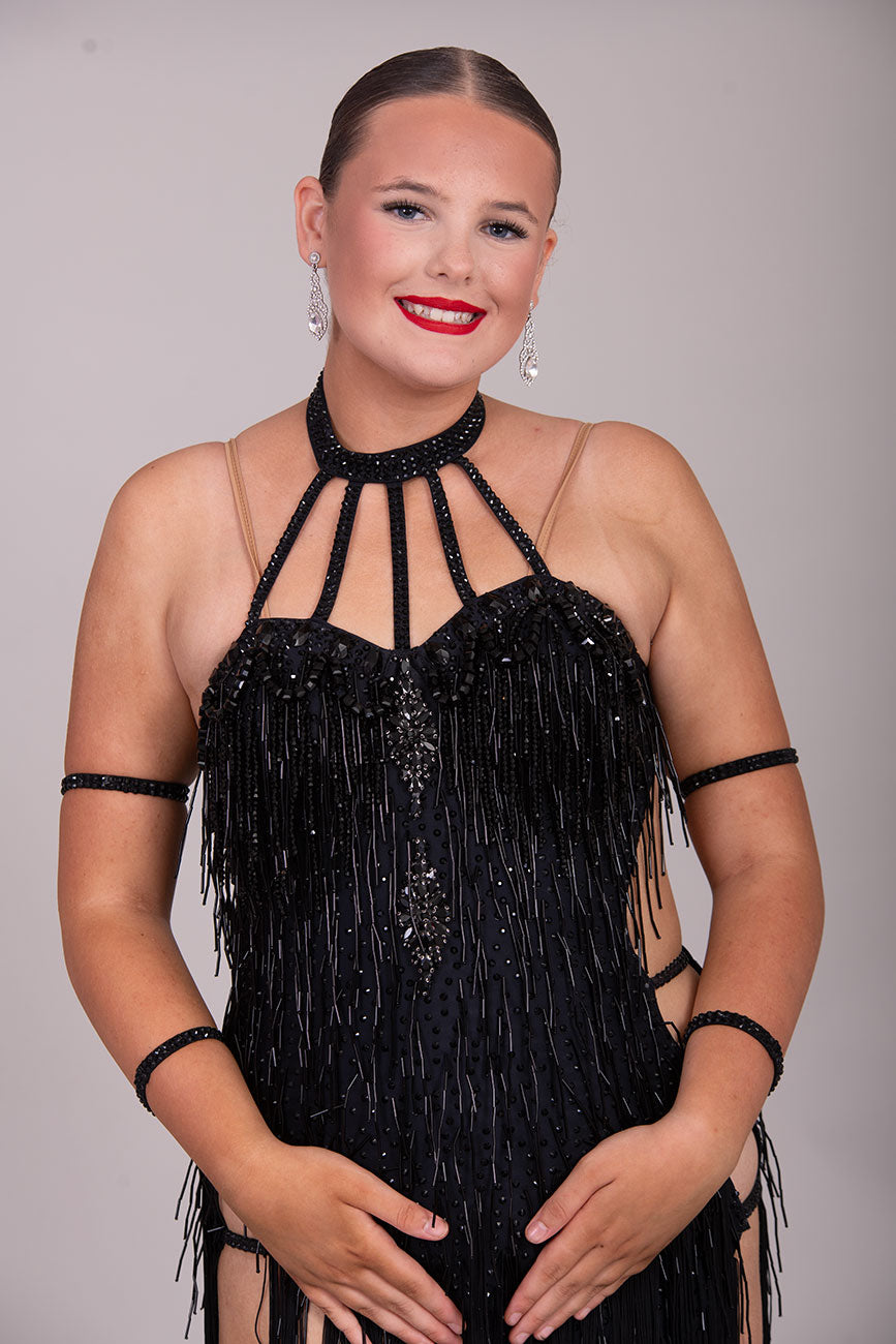 133L BUDGET (23) Black  Competition Latin Dance Dress. Beading detail to upper chest. Bead droppers with fringed skirt  Stoned in jet ❤️Showroom Appointments Available❤️
