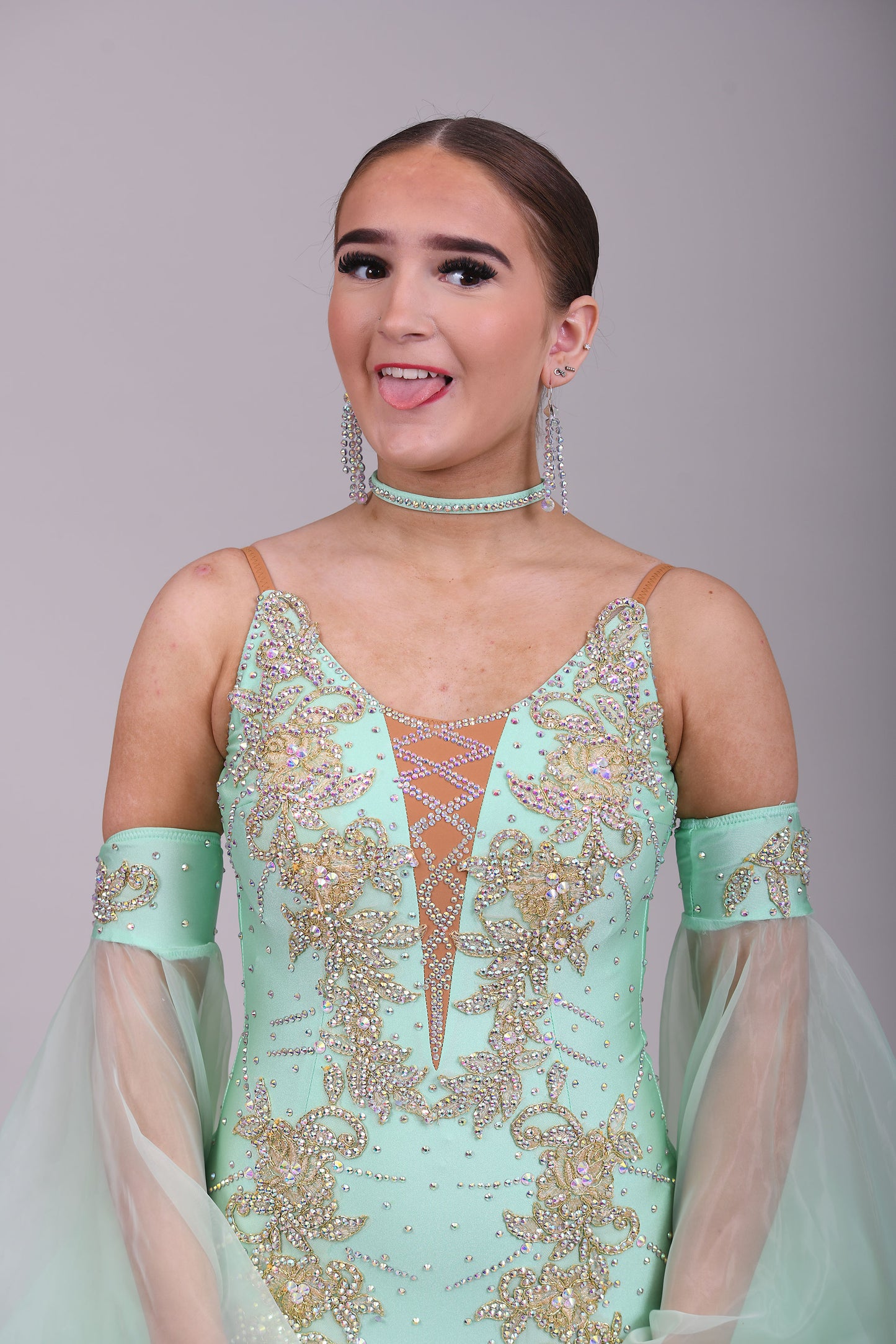 327 mint Green & Gold Ballroom Dress. Decorated with Gold motifs & AB Stones. Comes with separate floaty sleeve cuffs.