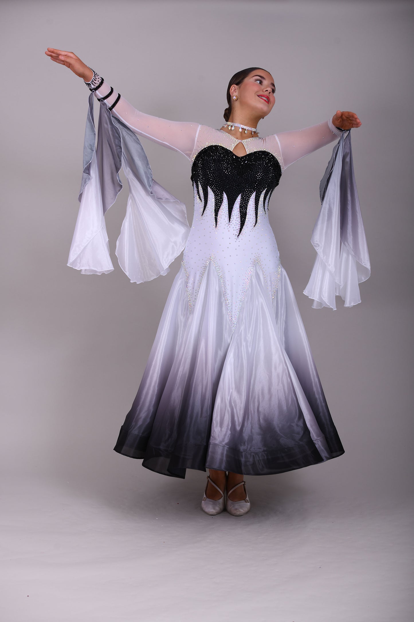 01140 Black & White Ombre Competition Ballroom Dance Dress Upper chest heavily stoned Jet. Pearl Chiffon Ombre skirts. The upper chest is white mesh with skin fabric underneath, giving the illusion of skin. Detachable Floats.