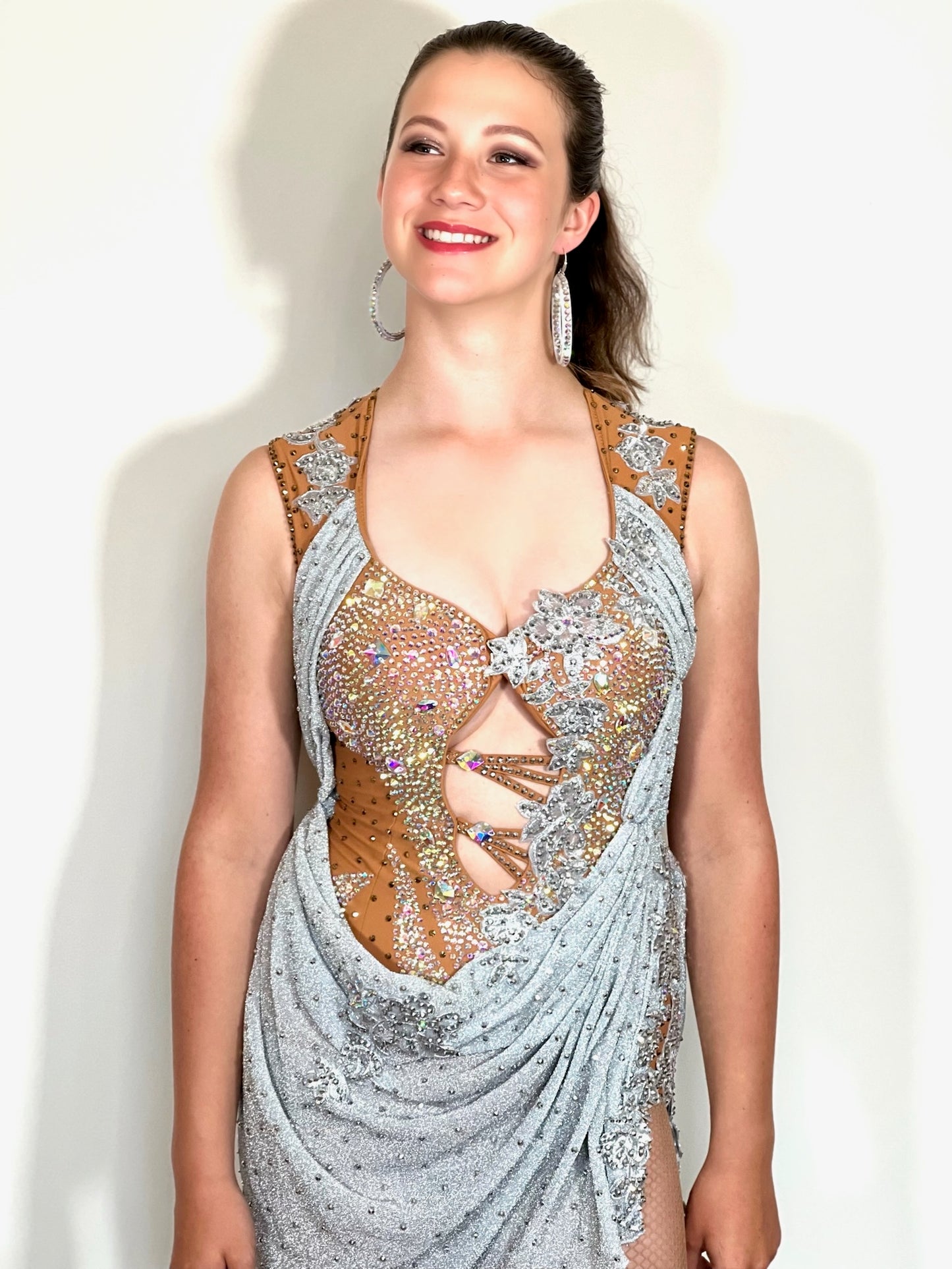 346 Silver Heavily decorated Latin Dress. Decorated with lilac flowers with full back. Front fastening. Decorated with silver motifs & AB stones