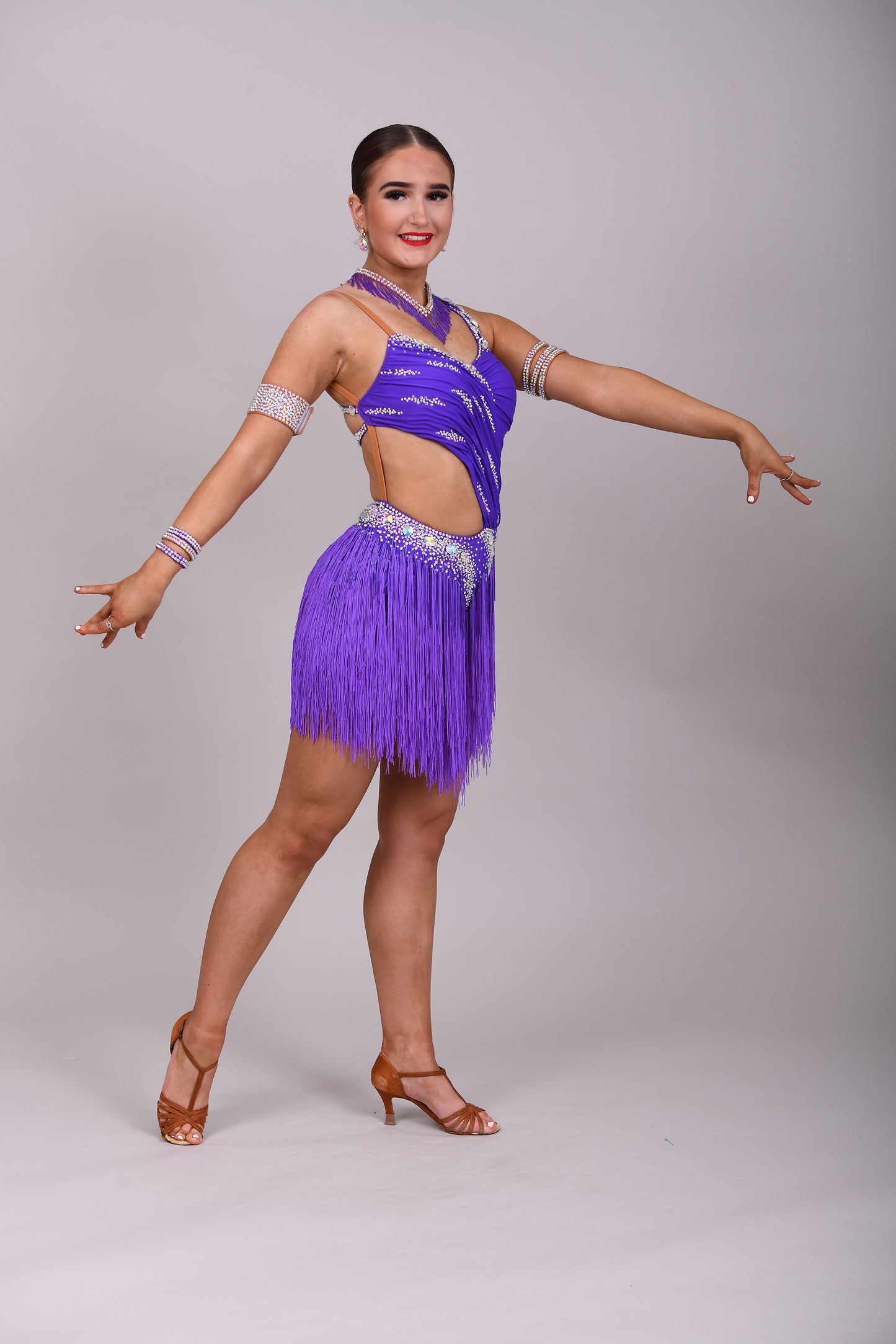 173 Cadbury Purple Latin dance dress. Rouched detailing to the upper body, full fringed skirt. Stoned in AB