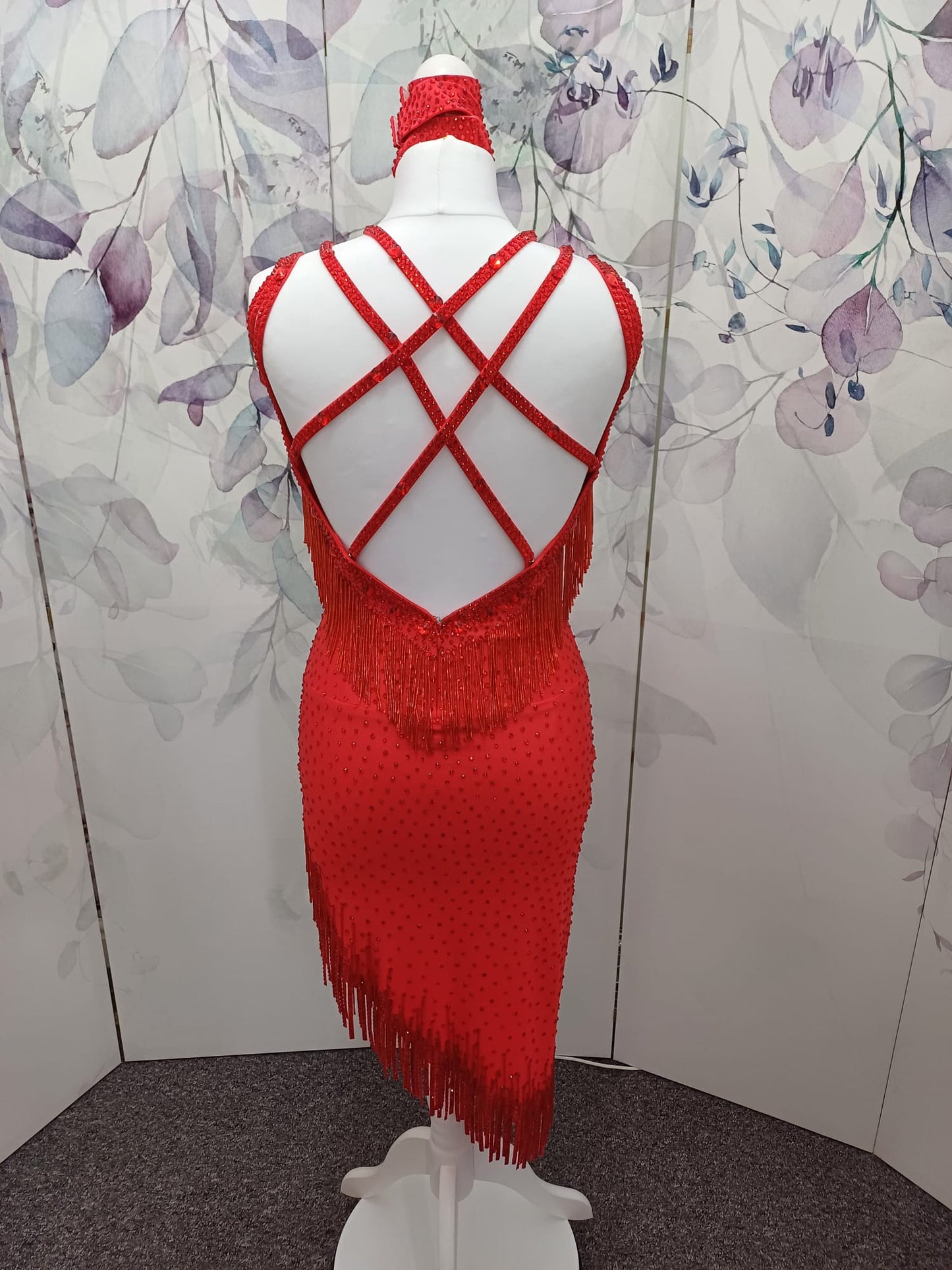 41L Red Latin Competition Dance Dress. Stoned in light Siam with strapping feature to the back & front. Bead droppers added to the hem for movement & upper chest.