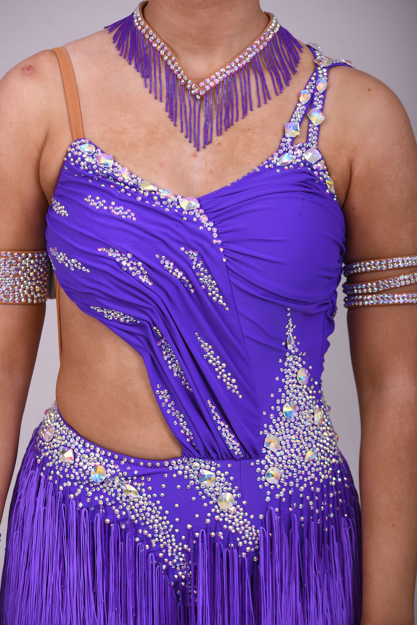 173 Cadbury Purple Latin dance dress. Rouched detailing to the upper body, full fringed skirt. Stoned in AB