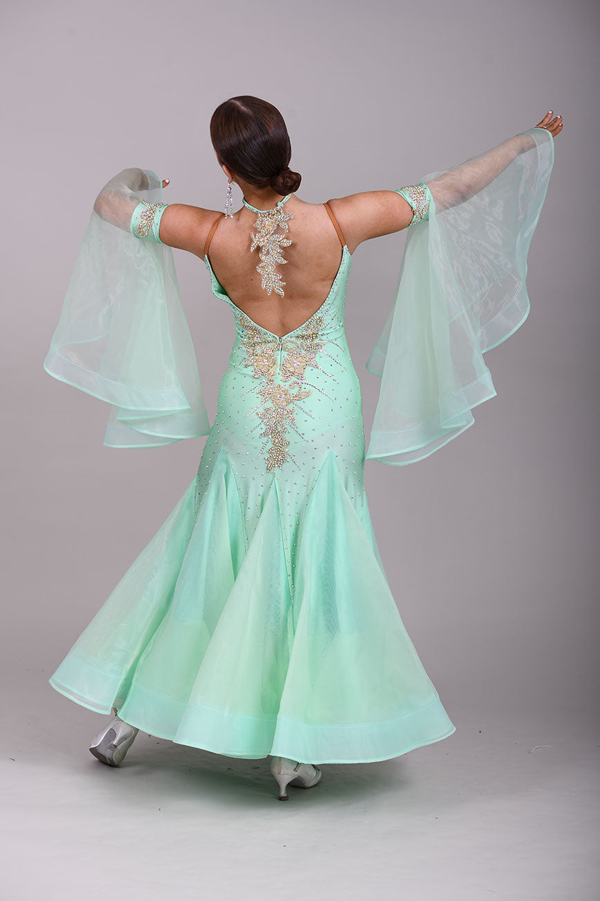 327 mint Green & Gold Ballroom Dress. Decorated with Gold motifs & AB Stones. Comes with separate floaty sleeve cuffs.