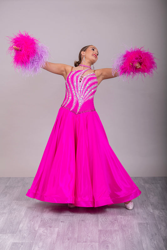 005 Cerise Pink Competition Ballroom Dance Dress. Heavily stoned in AB and Fuchsia & lilac. Comes with ostrich cuffs in Lilac & Cerise. Beautiful back detail.