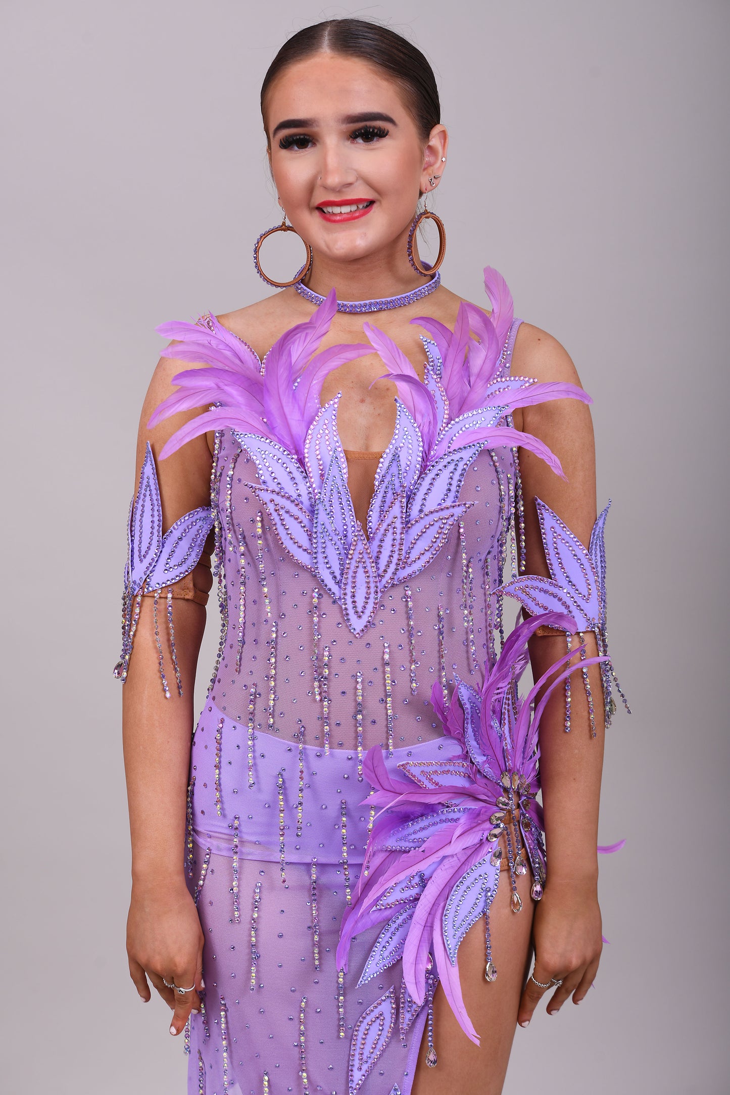 160 Lilac Latin dance dress. Stunning feather detailing to the upper chest & hip. Mesh fabric dress.