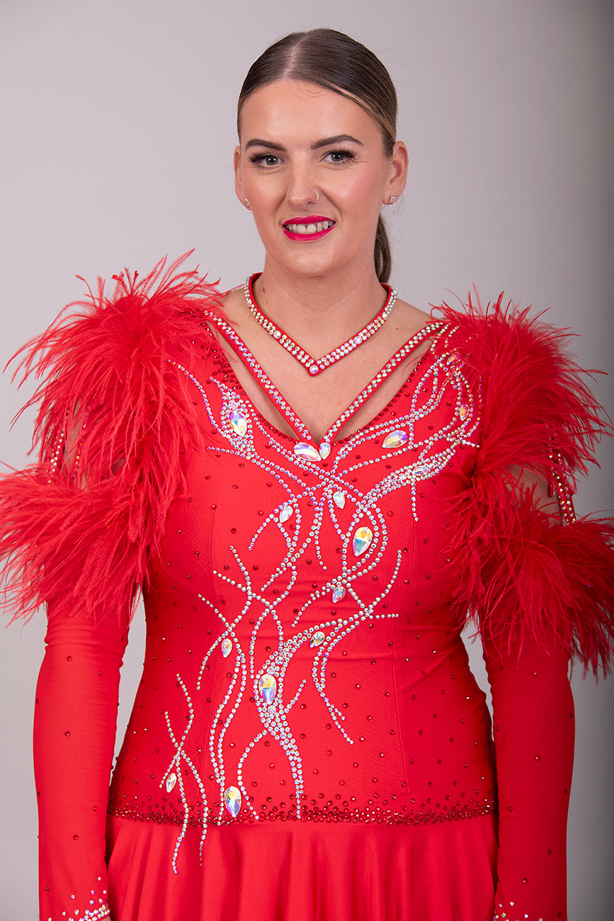301 Rich Red Competition Latin Dance Dress. Ostrich boa decoration to the upper arm with stoned strap detail. Very full skirt. Stoned in Light Siam & AB