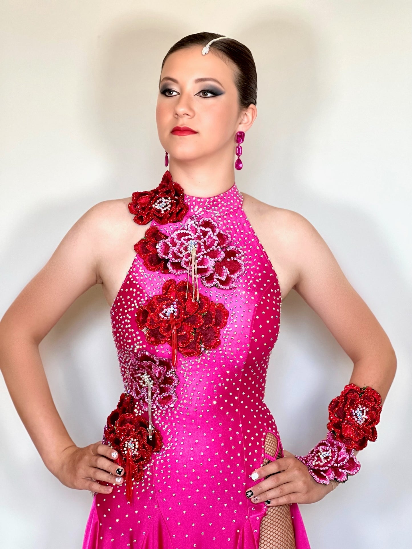 018 Magenta Halter neck style Latin dress. Shaped skirt with side split. 3D flower decorations to the front & back of bodice. Flowers to wrist cuff.