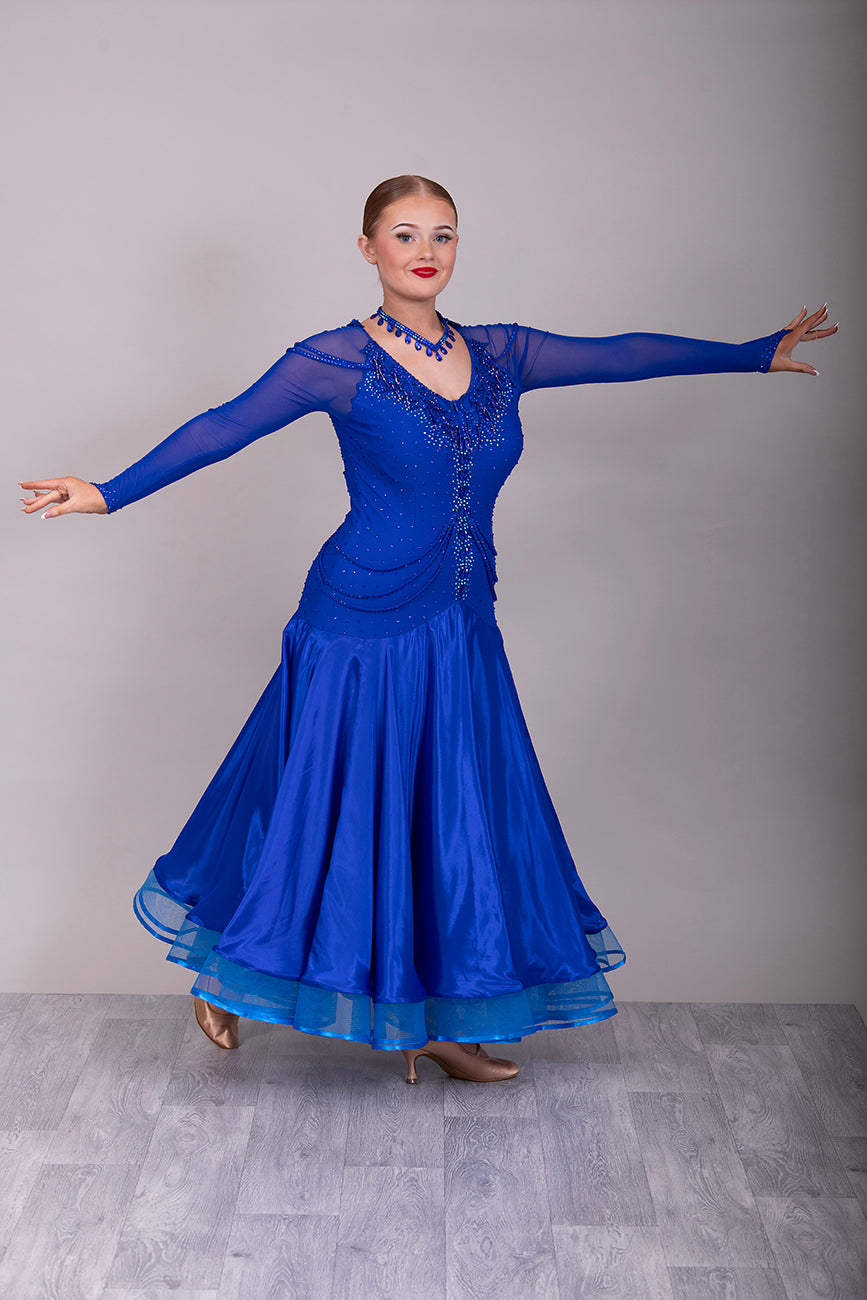 339 Bright Royal Blue Ballroom Dress. Stunning detailing to the back with Strappy detail to the hips. Organza edged in ribbon. All stoned in Bright Royal Blue. Very comfortable Front Zip fastening.