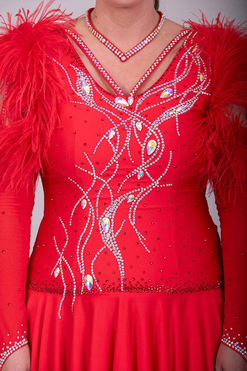 301 Rich Red Competition Latin Dance Dress. Ostrich boa decoration to the upper arm with stoned strap detail. Very full skirt. Stoned in Light Siam & AB