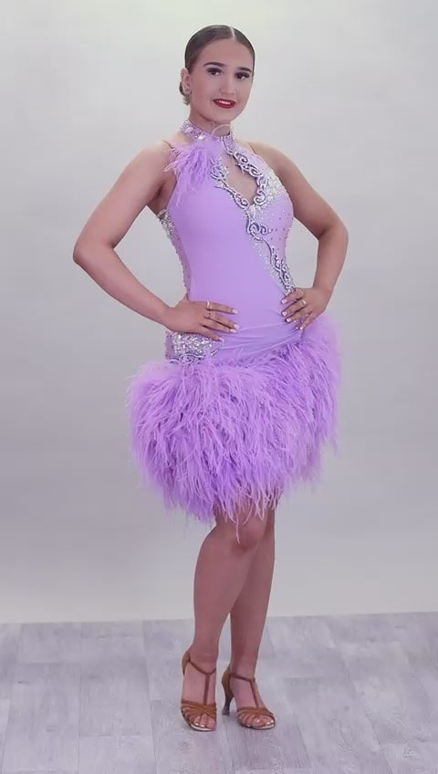 344 Lilac Latin Dress with keyhole halter neck detail. Strapping design on back. Lilac ostrich feather boa skirt. Decorated with purple motif. Stoned in green & AB Boa is hand stitched so could be rearranged
