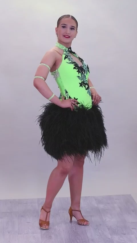 343 Flo Green & Black Latin Dress with keyhole halter neck detail. Strapping design to the back. Full ostrich feather skirt. Decorated with black motifs & stoned in Het AB & AB Boa is hand stitched so could be rearranged
