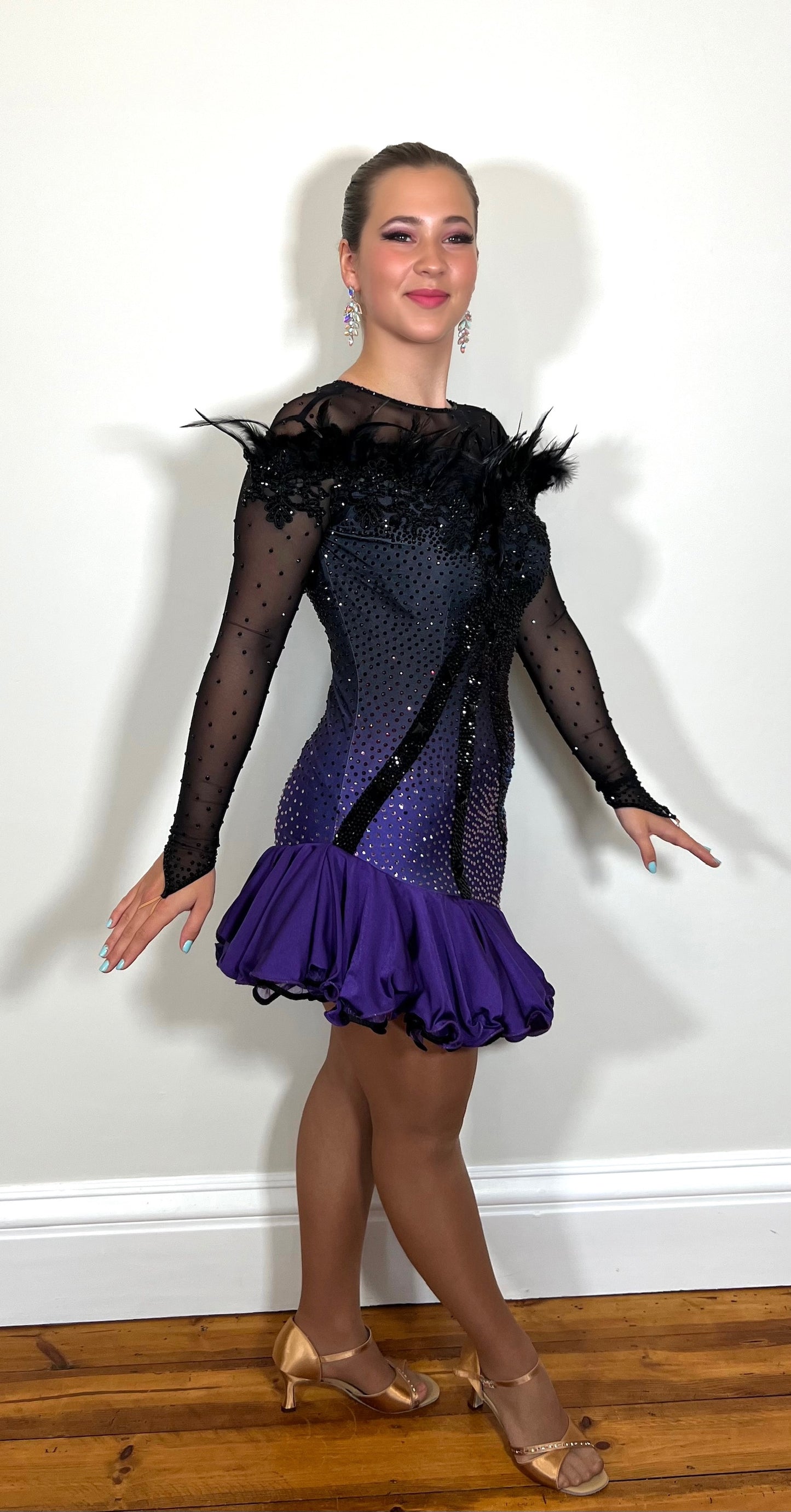 194 Standout Latin Dance Dress. Black to purple ombre with full frill skirt. Decorated with ostrich feather trim, purple & jet stones.