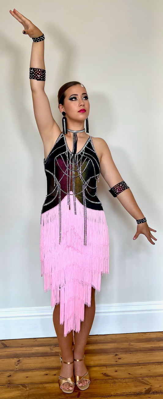 087 Black & Pink layered Fringe Latin Dress. Rainbow metallic bodice with stoned materials drapes & droppers. Backless dress with material droppers.