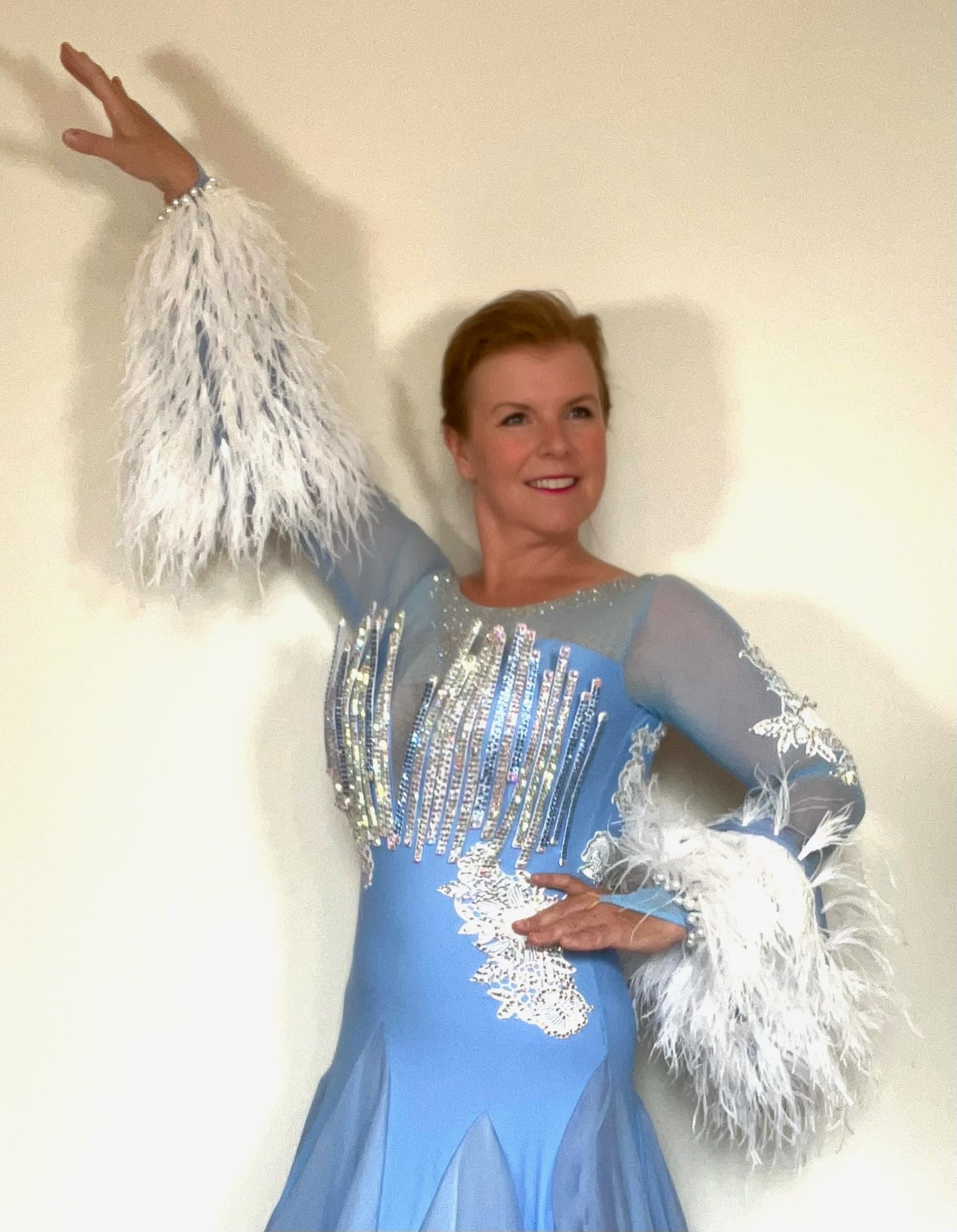 335 Cornflower Blue & White Ballroom Dress. Rigid detailing to the chest and lower back with white appliqué detail. White Ostrich feather detached cuffs. Stoning in light Saphire & AB.