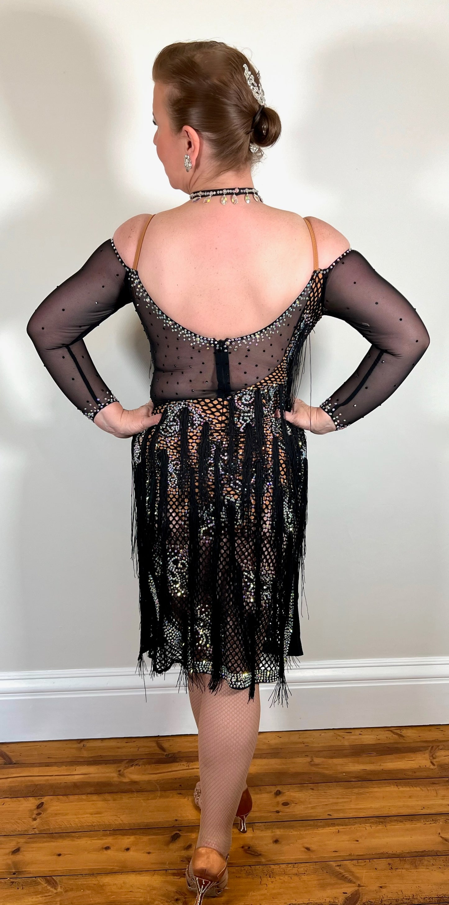 068 Black & Tan Wide fishnet Competition Latin Dance Dress. Hanging fringe detailing all over. Heavily stoned in crystal golden shadow, topaz & AB. Cold shoulder & one strap detailing to one arm with full shoulder to the other arm