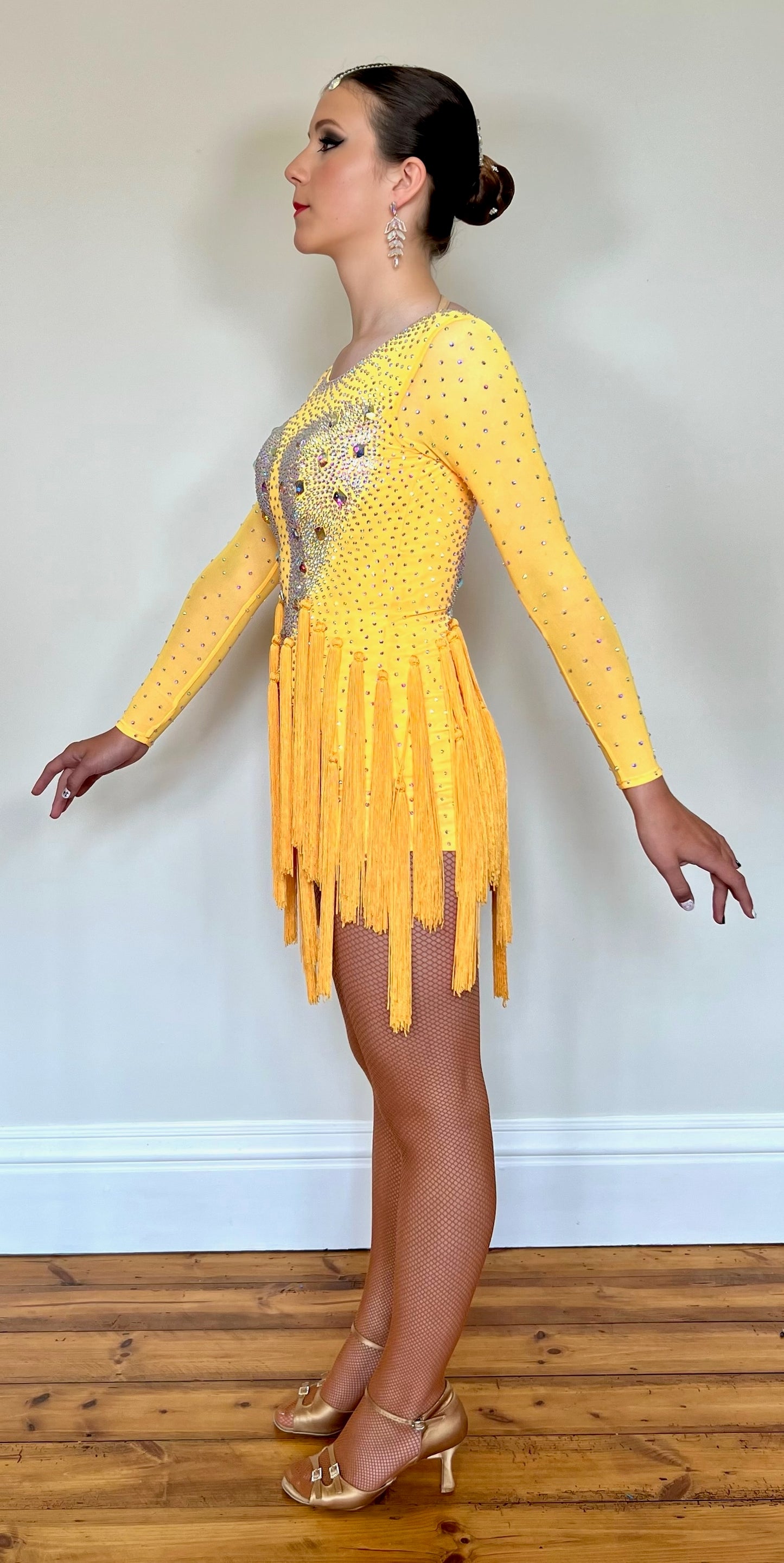 021 Golden Yellow tasseled skirt Latin dress. Decorated in AB with stoned sleeves.
