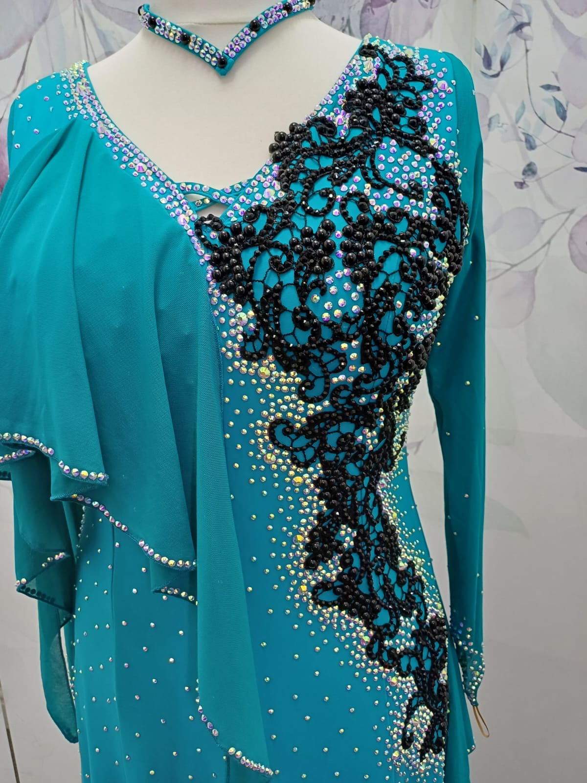 60L Teal Competition Latin Dance Dress. Beautiful Teal colour. Black pearls & AB stones with overlay detail to the chest & Back hip giving flattering lines. ❤️Showroom Appointments Available❤️