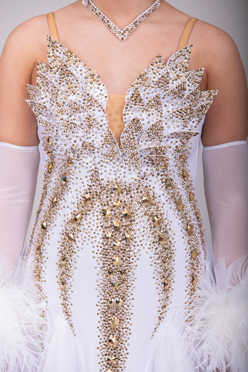 012 Stand out White & Gold Competition Ballroom Dance Dress. 3D design to the Bodice heavily stoned in Gold Ore & Golden Shadow. Detachable Floats with Ostrich feather cuffs.