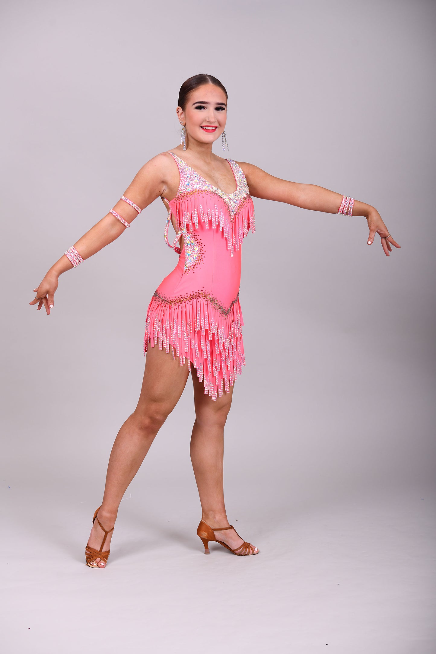 003 Coral Competition Latin Dance Dress. Full stoned fabric fringe details to chest and skirt. Includes bracelets. Stoned in AB & Hyacinth AB