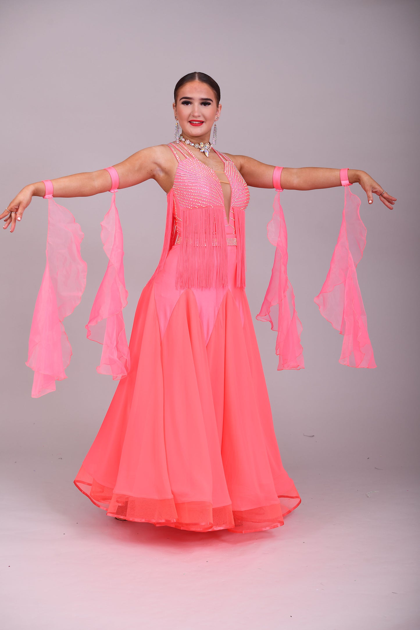 237 Bright Coral Fringed Dress. Decorated in AB stones with strapping detail to the shoulders & back. Matching Skirt, Floats & Belt available on request £135 extra