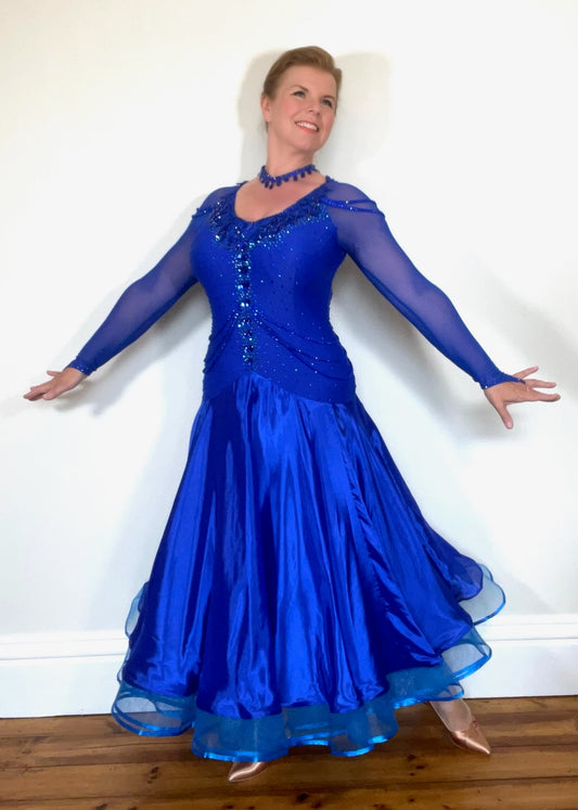 339 Bright Royal Blue Ballroom Dress. Stunning detailing to the back with Strappy detail to the hips. Organza edged in ribbon. All stoned in Bright Royal Blue. Very comfortable Front Zip fastening.