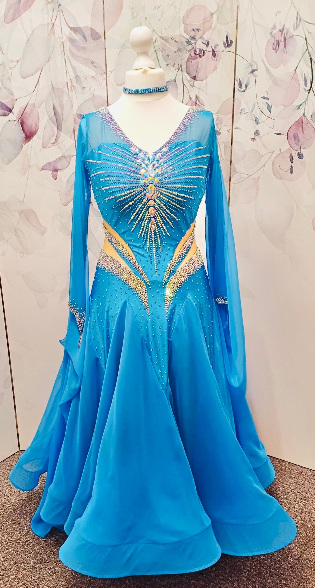 094 Turquoise Competition Ballroom Dance Dress heavily decorated heavily decorated with AB & Capri Blue Stones. Flattering stoned strap detailing detailing to the waist area. High back to give option to wear own bra. Detachable floats