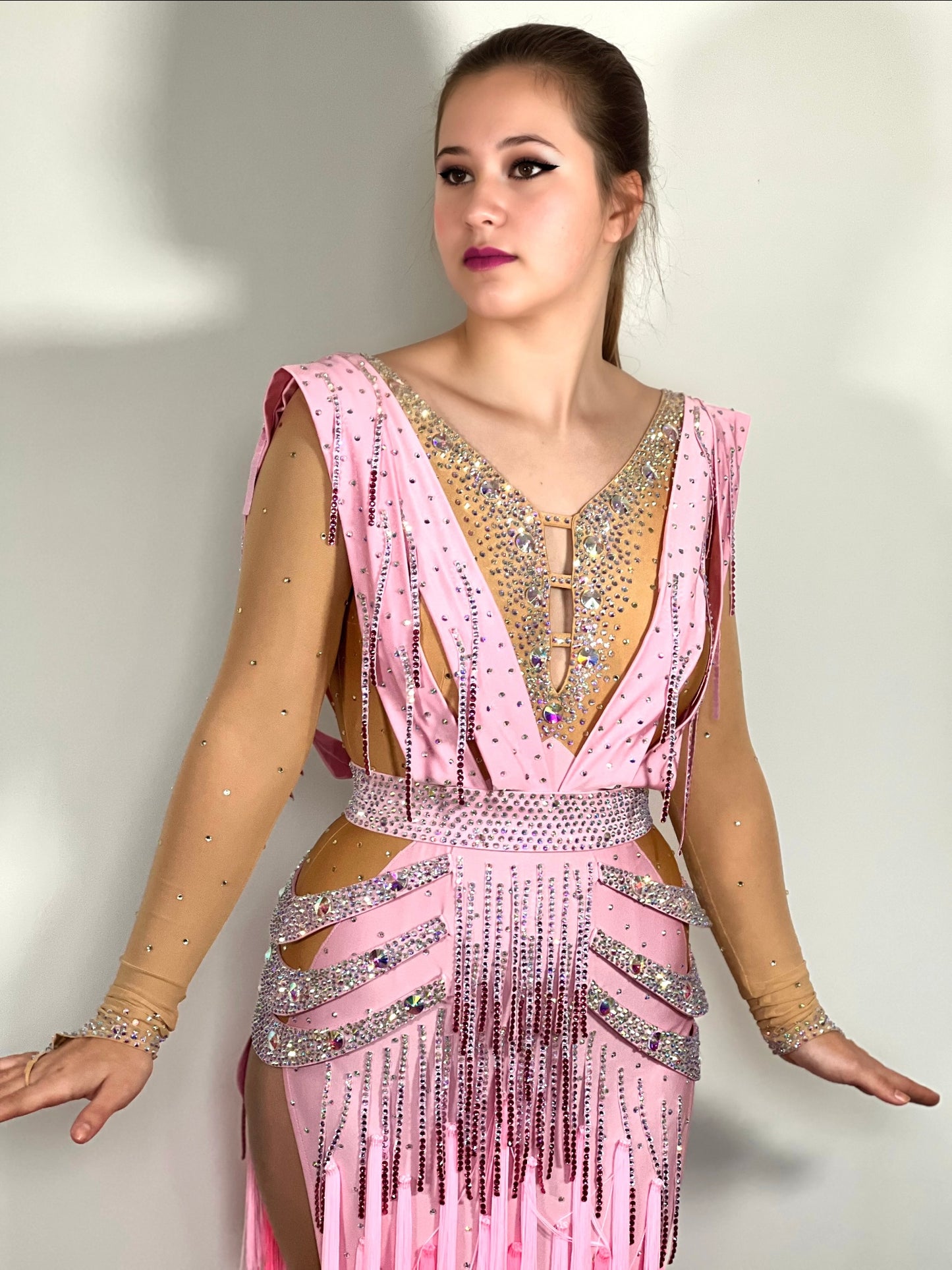 112 Ombré Fringed Latin Dress. Side strap detailing to the hips with sash feature at the back & front. Stoned in AB, Light Rose & Rose. Optional Belt