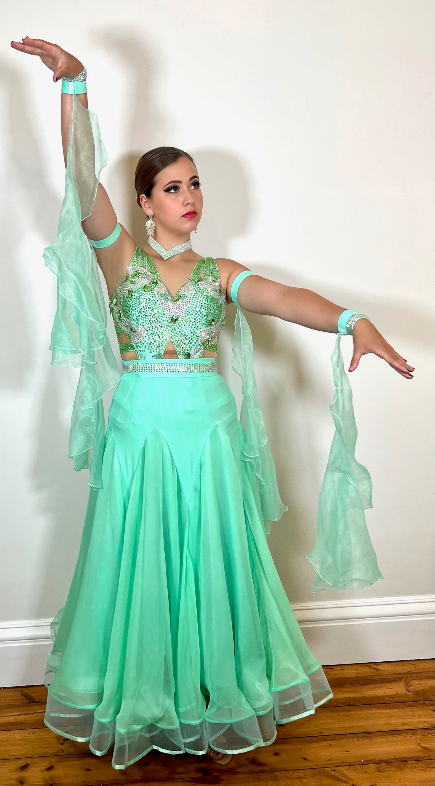 026 Mint Green Latin Dress with a Ballroom Skirt, x4 floats on bands & AB stoned belt. Latin dress with full material fringe, white motifs & stoned in AB