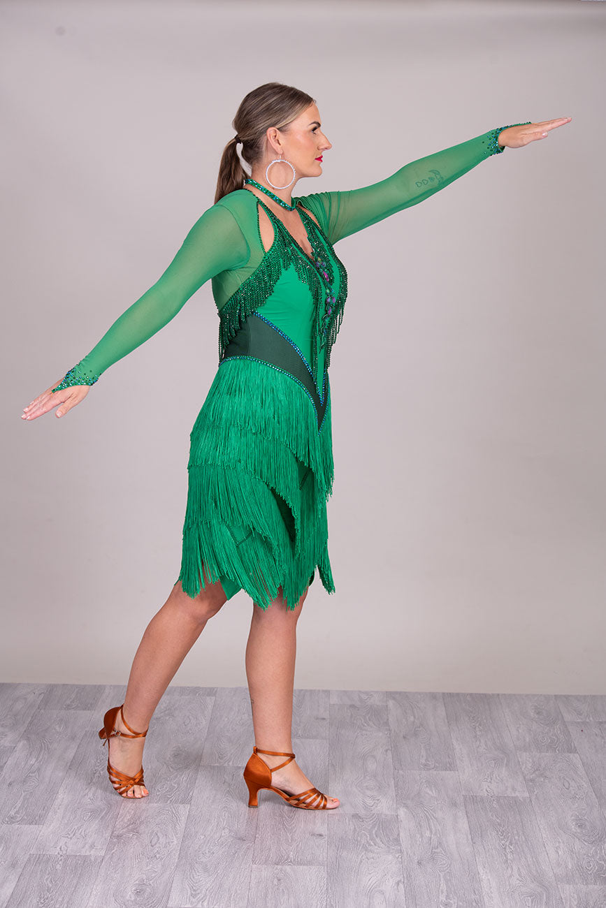 114L Deep Green Competition Latin Dance dress. Stunning Stone detail to the Front with open Detailing on the shoulder. Very Full fringed skirt
