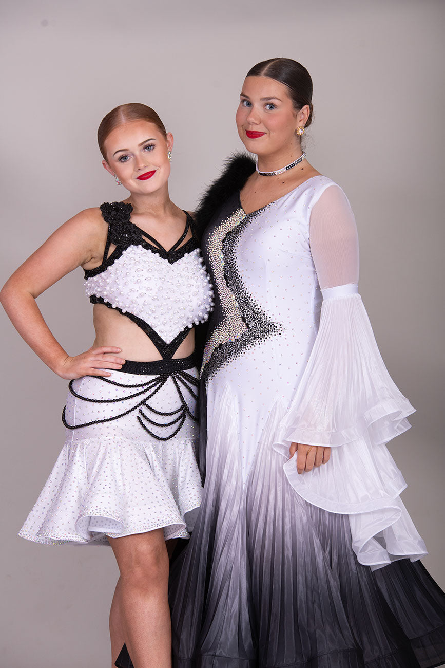(BUDGET)10 Striking White & Black Competition Latin Dance Dress. Heavily decorated with white pearls & Black bedding all over. Stoned black motif & flower detailing to the hip.