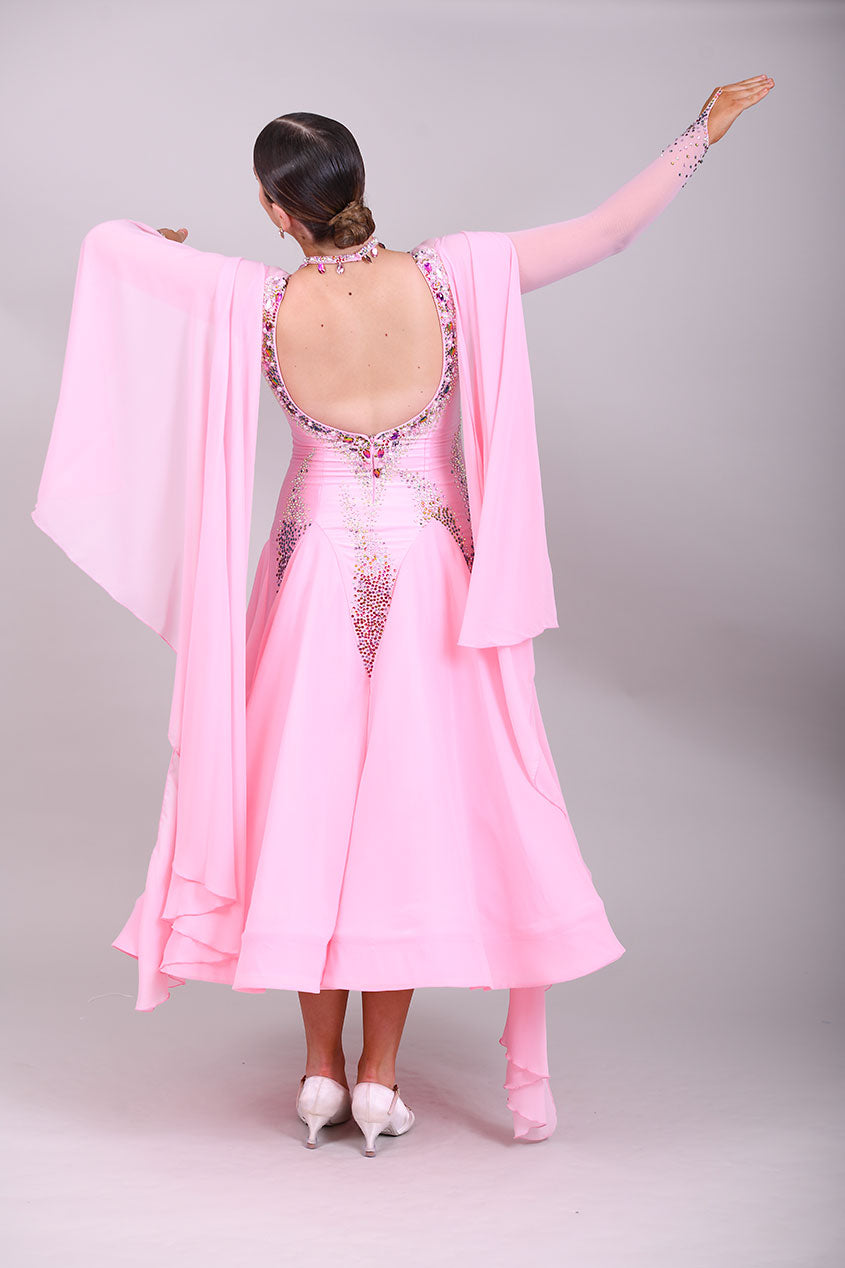 131 Pink Ballroom Dress with shoulder floats. Tan panel to the chest area giving a plunging neckline effect. Decorated in AB & Fuchsia stones