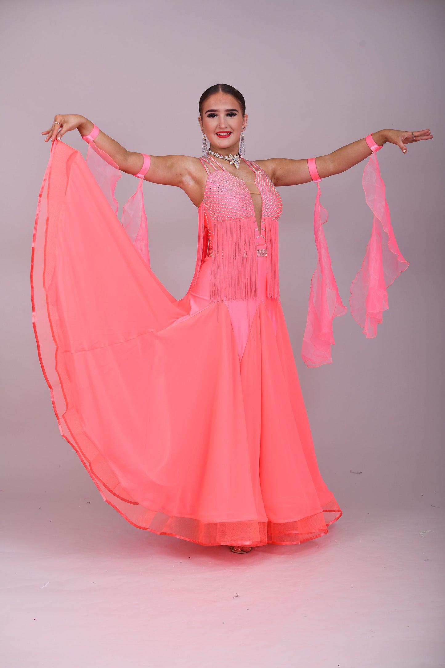 237 Bright Coral Fringed Dress. Decorated in AB stones with strapping detail to the shoulders & back. Matching Skirt, Floats & Belt available on request £135 extra