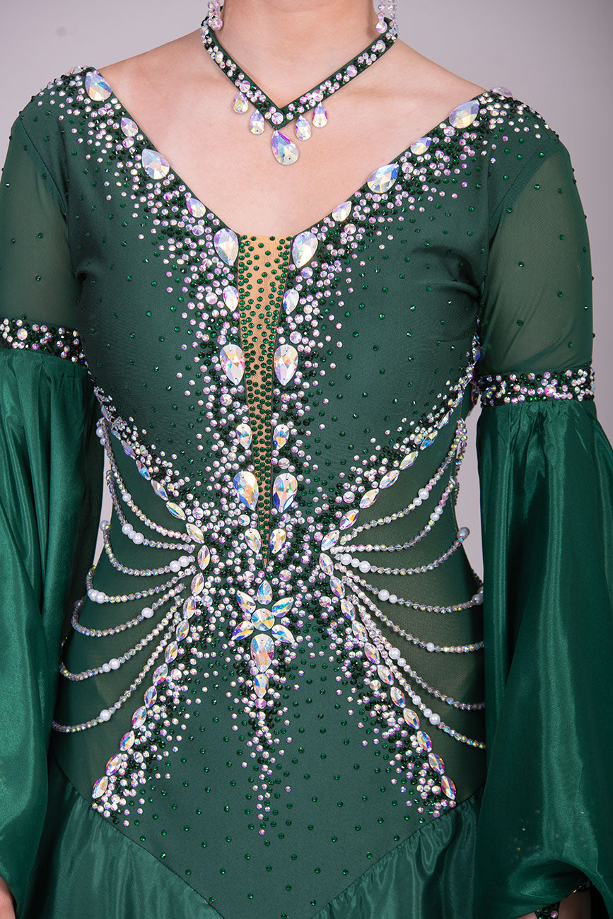 50B TWD “PETITE” Jade Green Competition Ballroom Dance Dress. Beautiful hanging strap detail on the hips. Heavily stoned in AB & Emerald & pearls. Bell sleeves. ❤️Showroom Appointments Available❤️