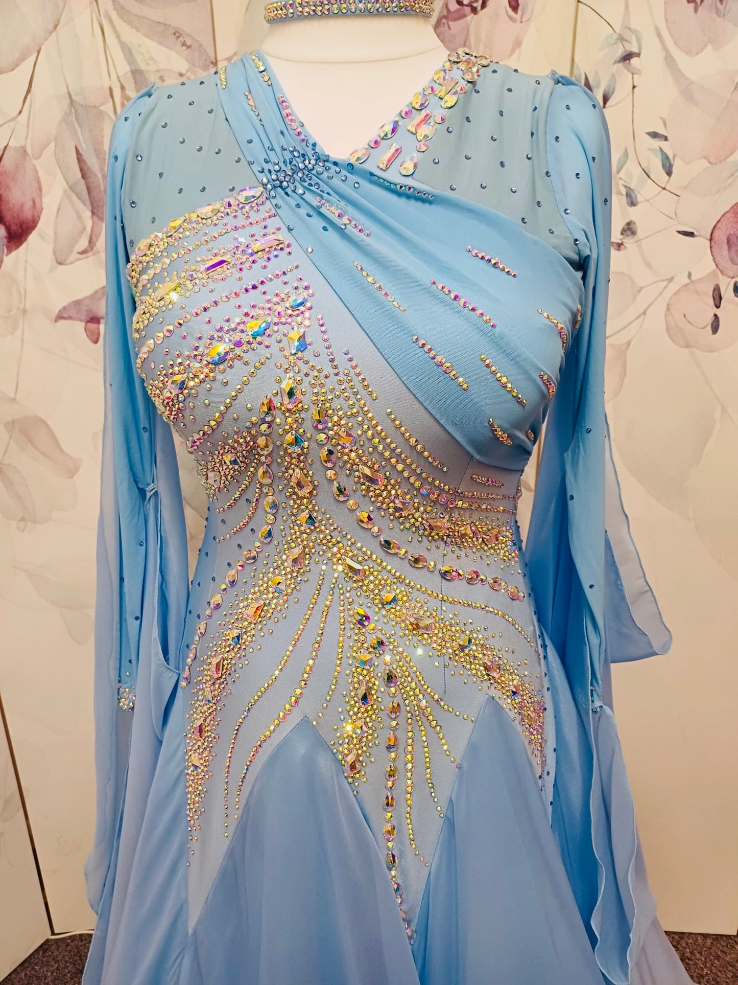 007 Light Blue Competition Ballroom Dance Dress. Heavily stoned in AB & Blue. Mesh overlay to one side of the bust continuing round to the back. Comes with detachable floats.