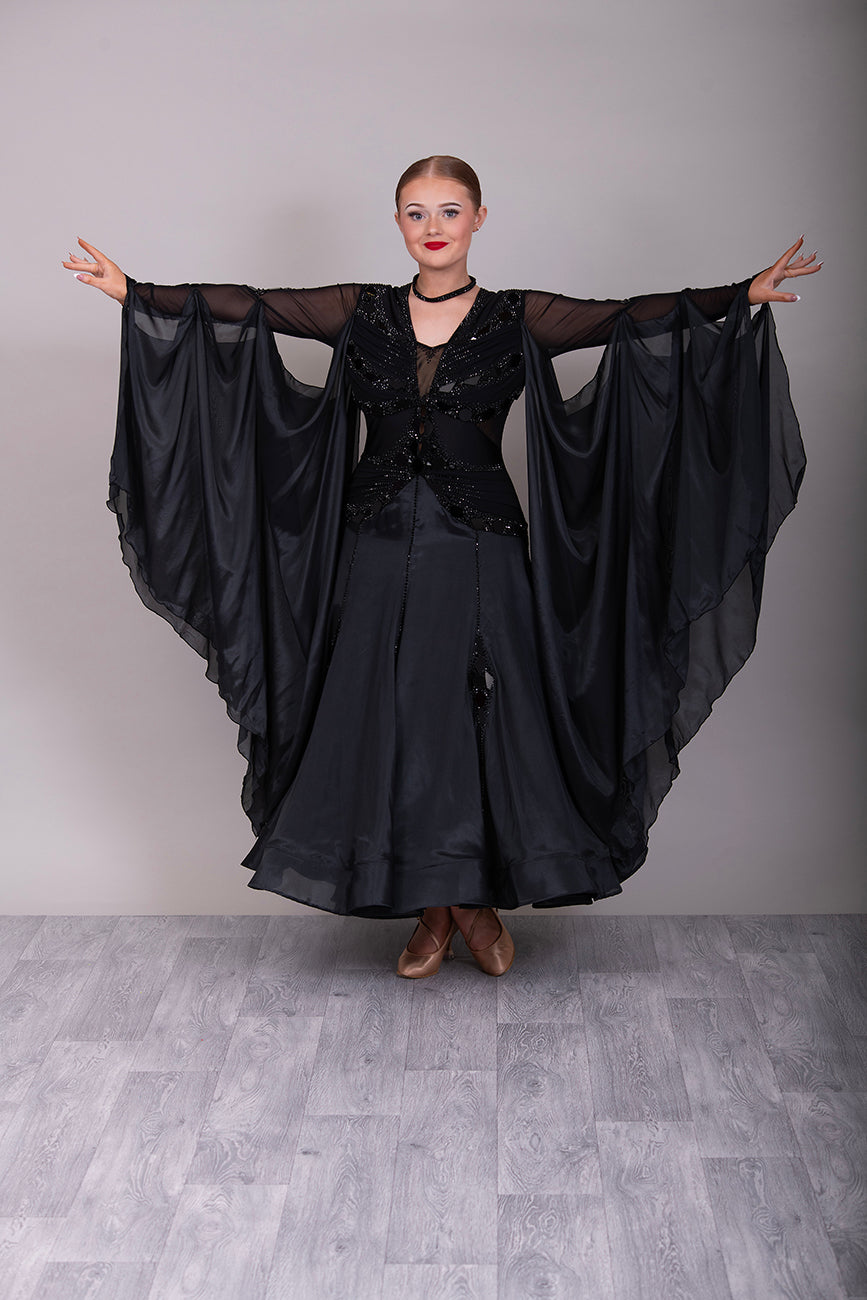 16B Black Ballroom/Sequence Competition Dance Dress. Heavily decorated in Black with Black Mirrors. Decoration continuing down into the Godet Points. A Stand Out & Sophisticated Dress