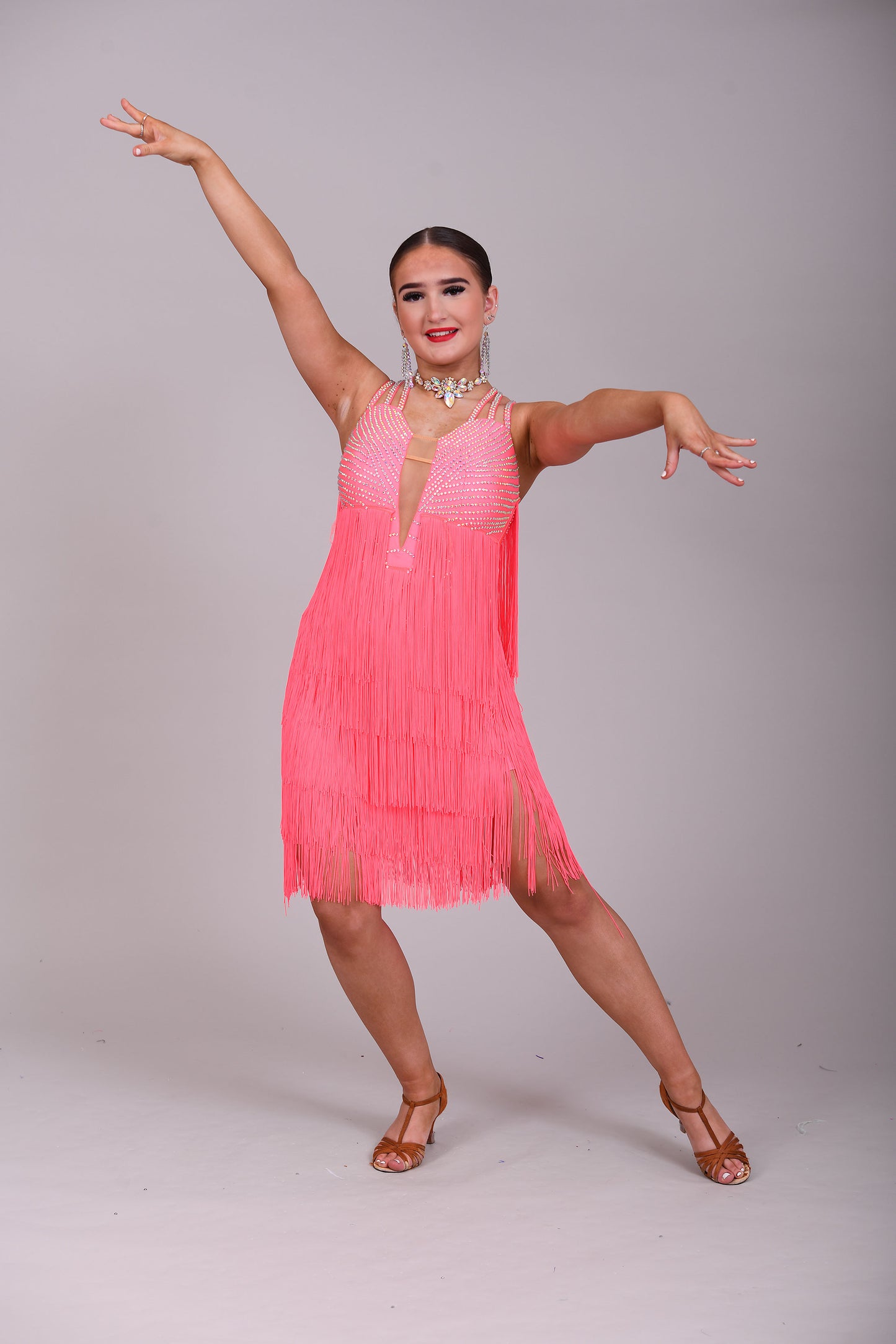 237 Bright Coral Fringed Dress. Decorated in AB stones with strapping detail to the shoulders & back. Matching Skirt, Floats & Belt available on request £135 extra