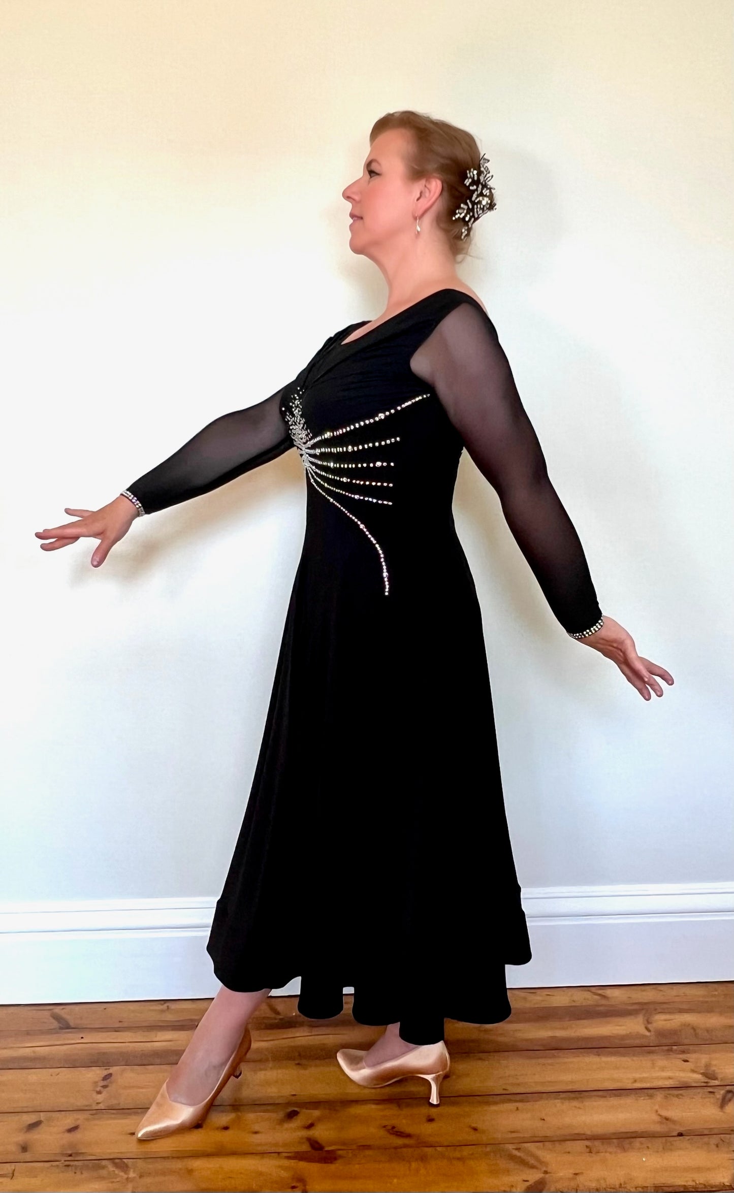 013 Black Crepe Ballroom Dress with AB stoning. Black mesh sleeves & ruched detailing to the chest.