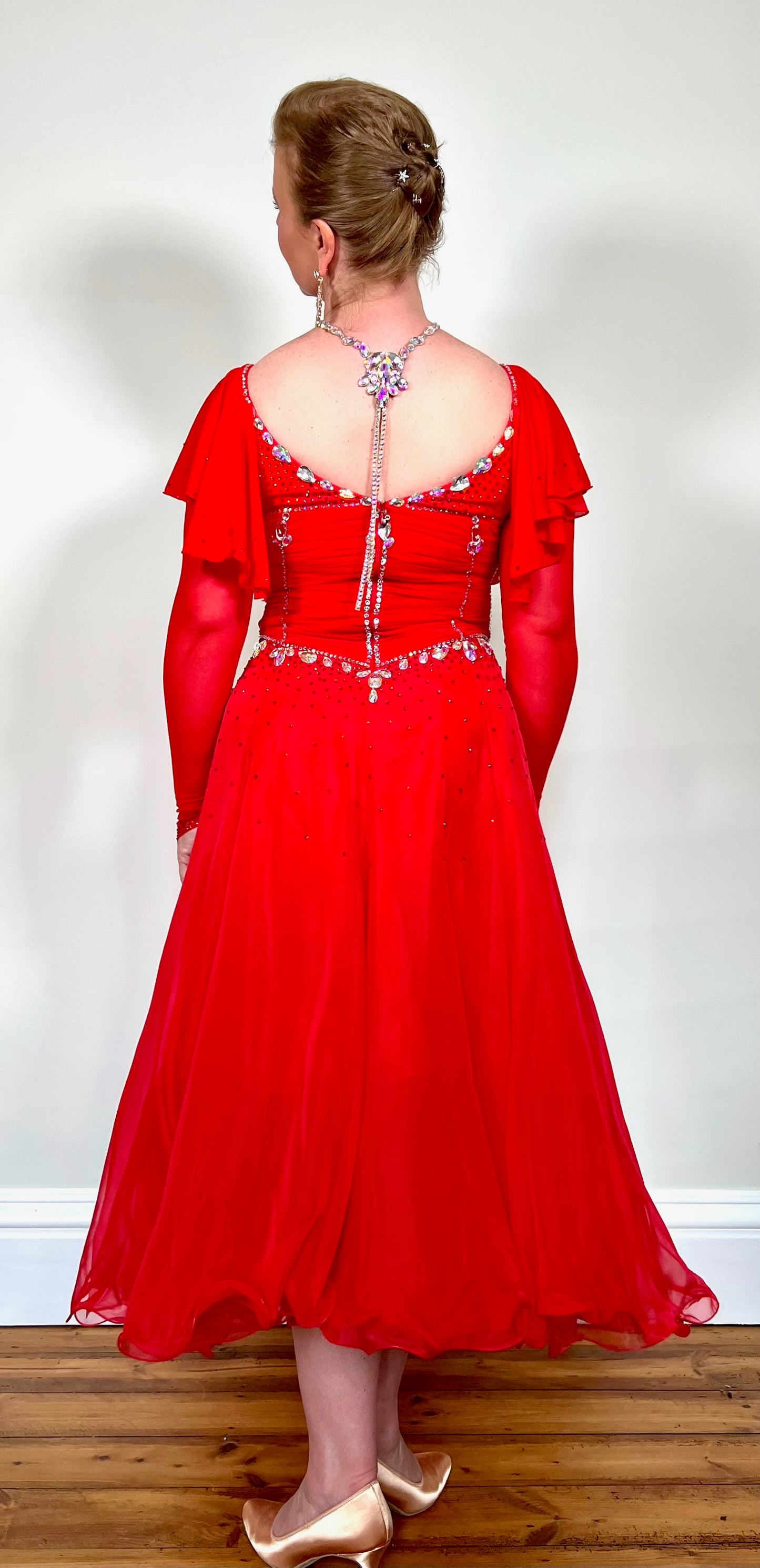 340 Red Rouched Bodice Ballroom Dress. Frill detail to top of sleeve with detachable ribbon floats. Detailed necklace. Decorated in Siam and AB stones.