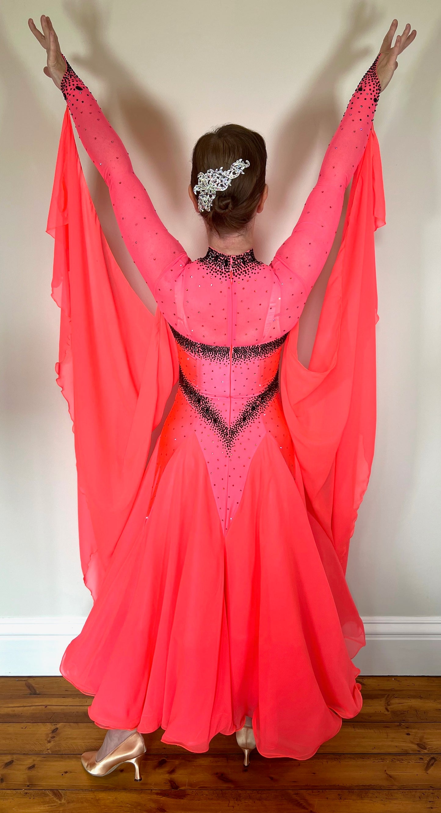 004 Striking Coral Ballroom Dress. Heavily decorated detailing in Jet stones. High back with detachable floats. A stand out eye catching dress.