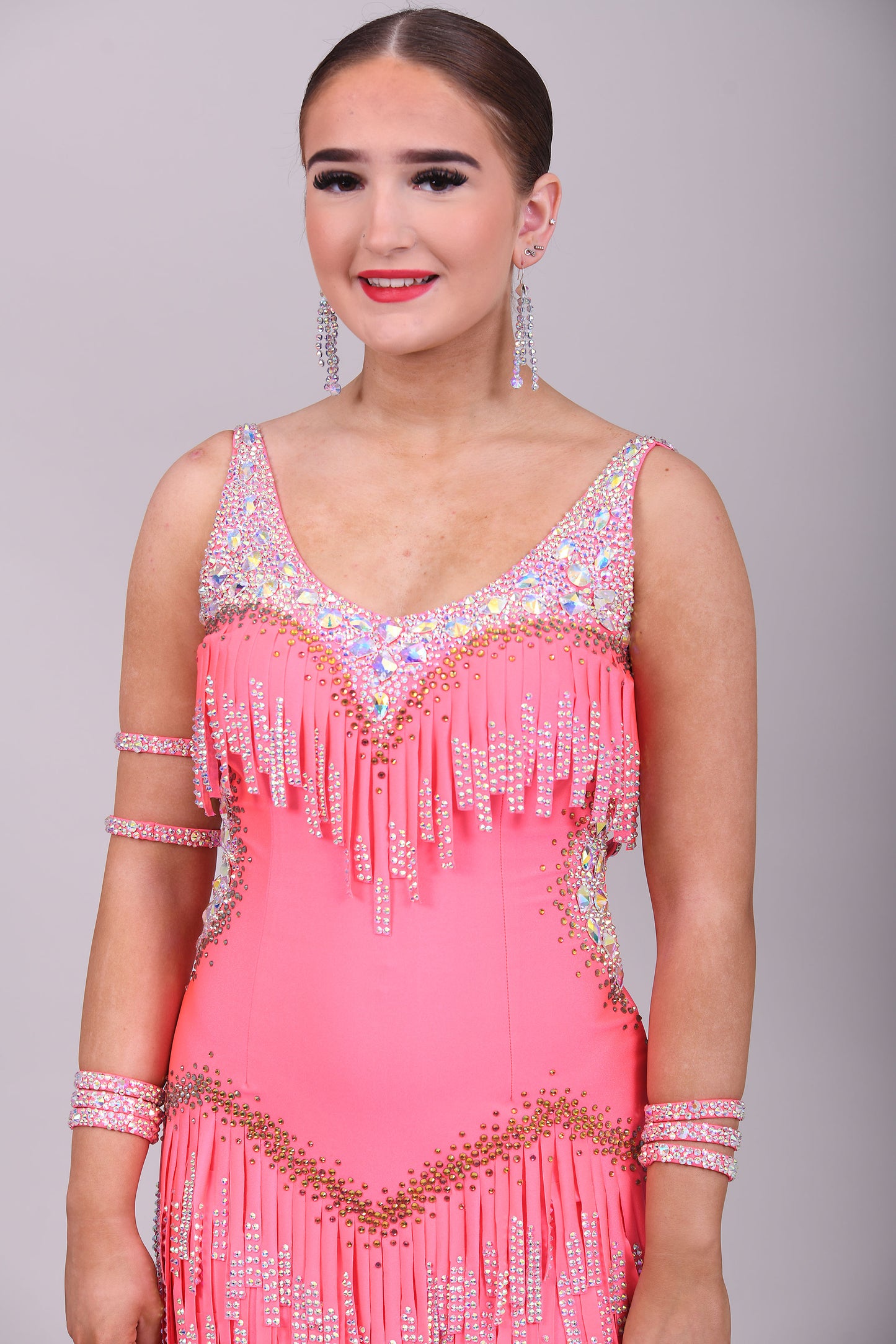 003 Coral Competition Latin Dance Dress. Full stoned fabric fringe details to chest and skirt. Includes bracelets. Stoned in AB & Hyacinth AB