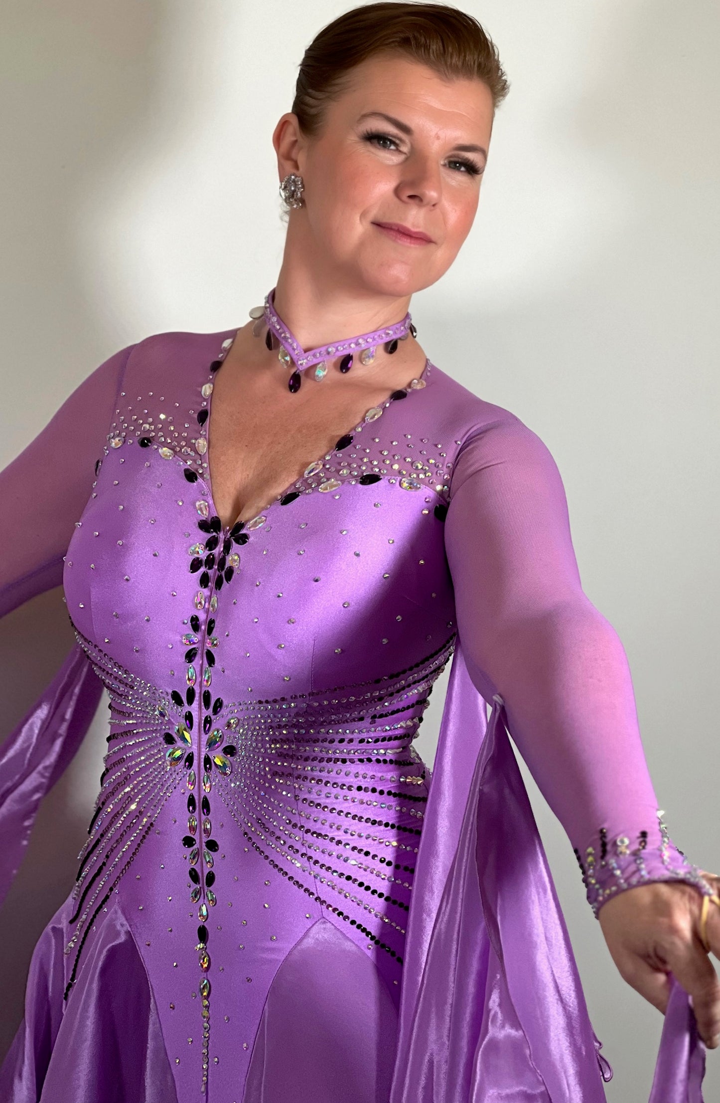 057 Lilac Dream Competition Ballroom Dance Dress. Comes with Detachable floats. High mesh on flesh Lycra back. Stoned in Purple velvet and AB