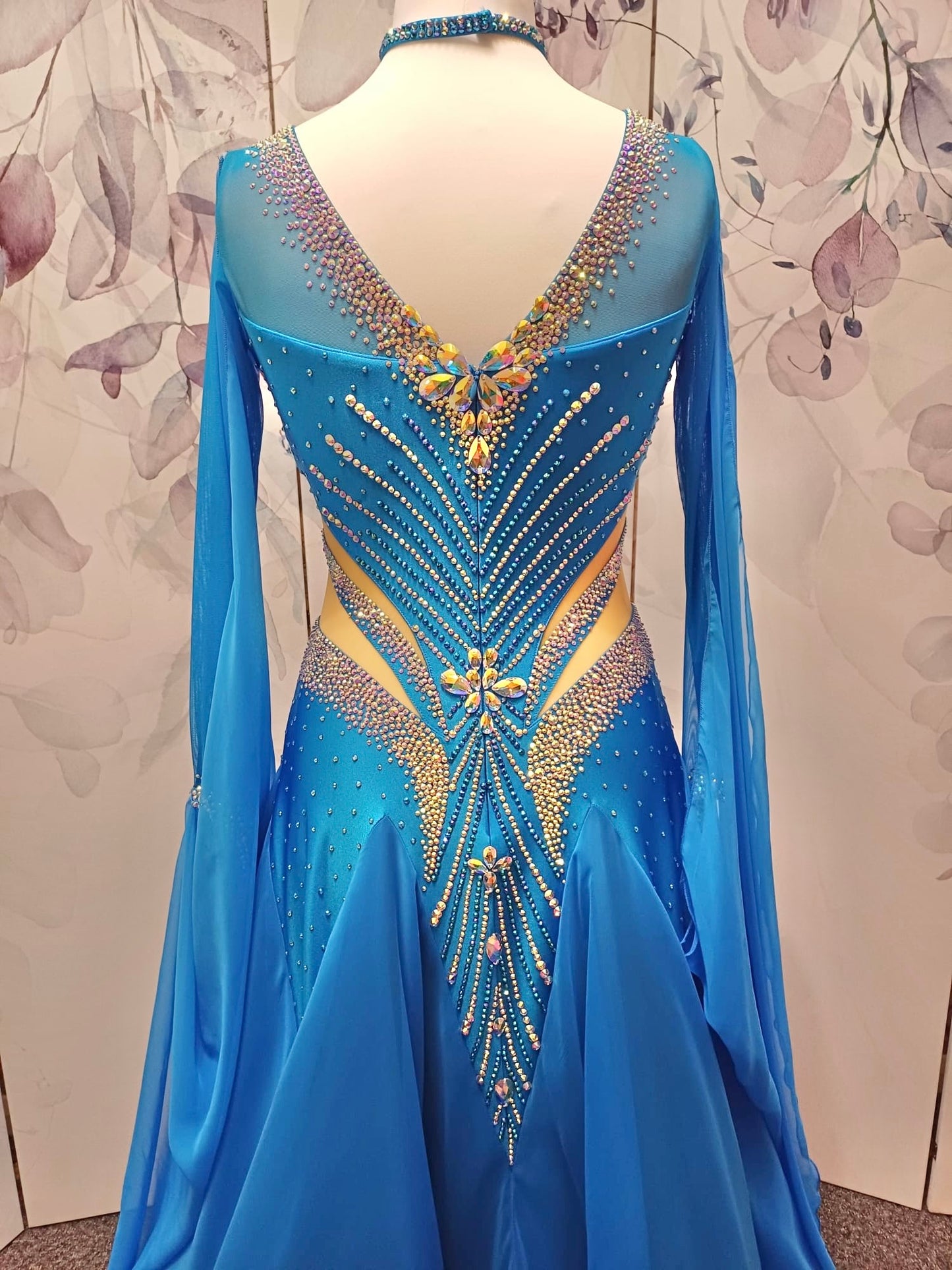 094 Turquoise Competition Ballroom Dance Dress heavily decorated heavily decorated with AB & Capri Blue Stones. Flattering stoned strap detailing detailing to the waist area. High back to give option to wear own bra. Detachable floats