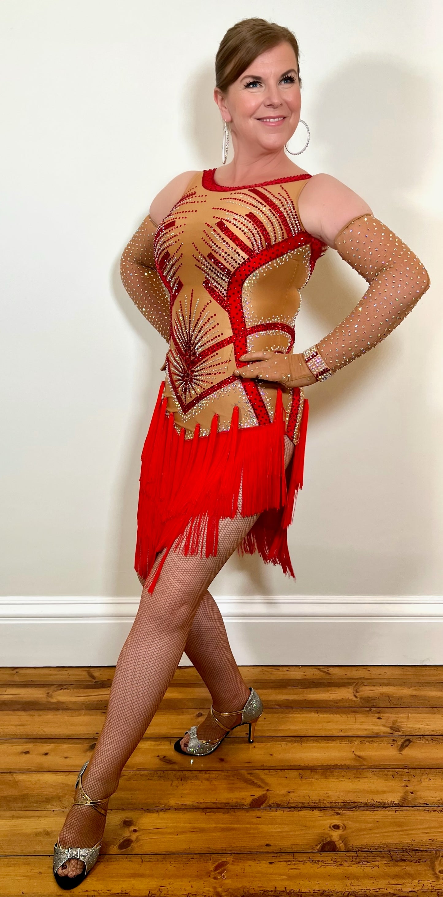 078 Red & Nude Latin Dress. Structured bodice design with red fringed skirt. Stoned in Siam & AB